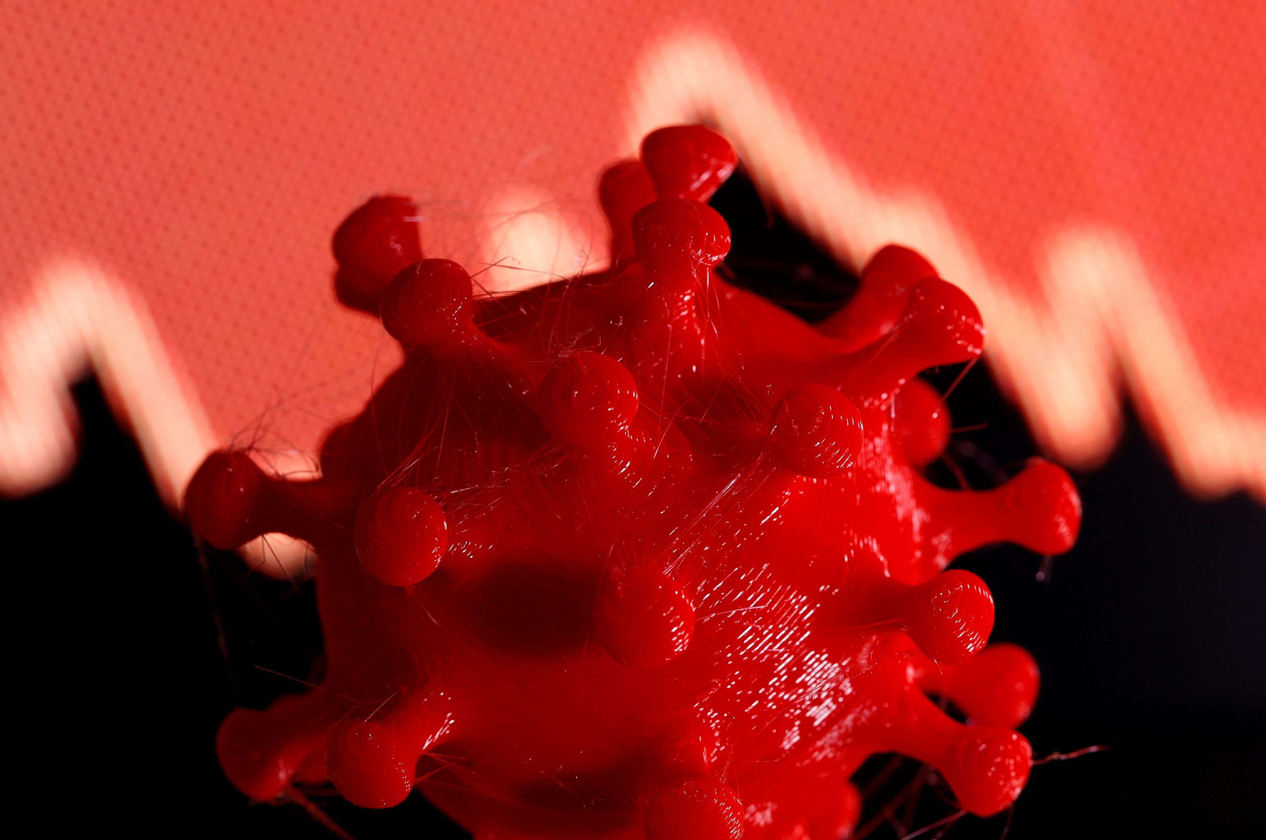 FILE PHOTO: A 3D-printed coronavirus model is seen in front of a stock graph on display in this illustration taken March 25, 2020. REUTERS/Dado Ruvic/Illustration/File Photo