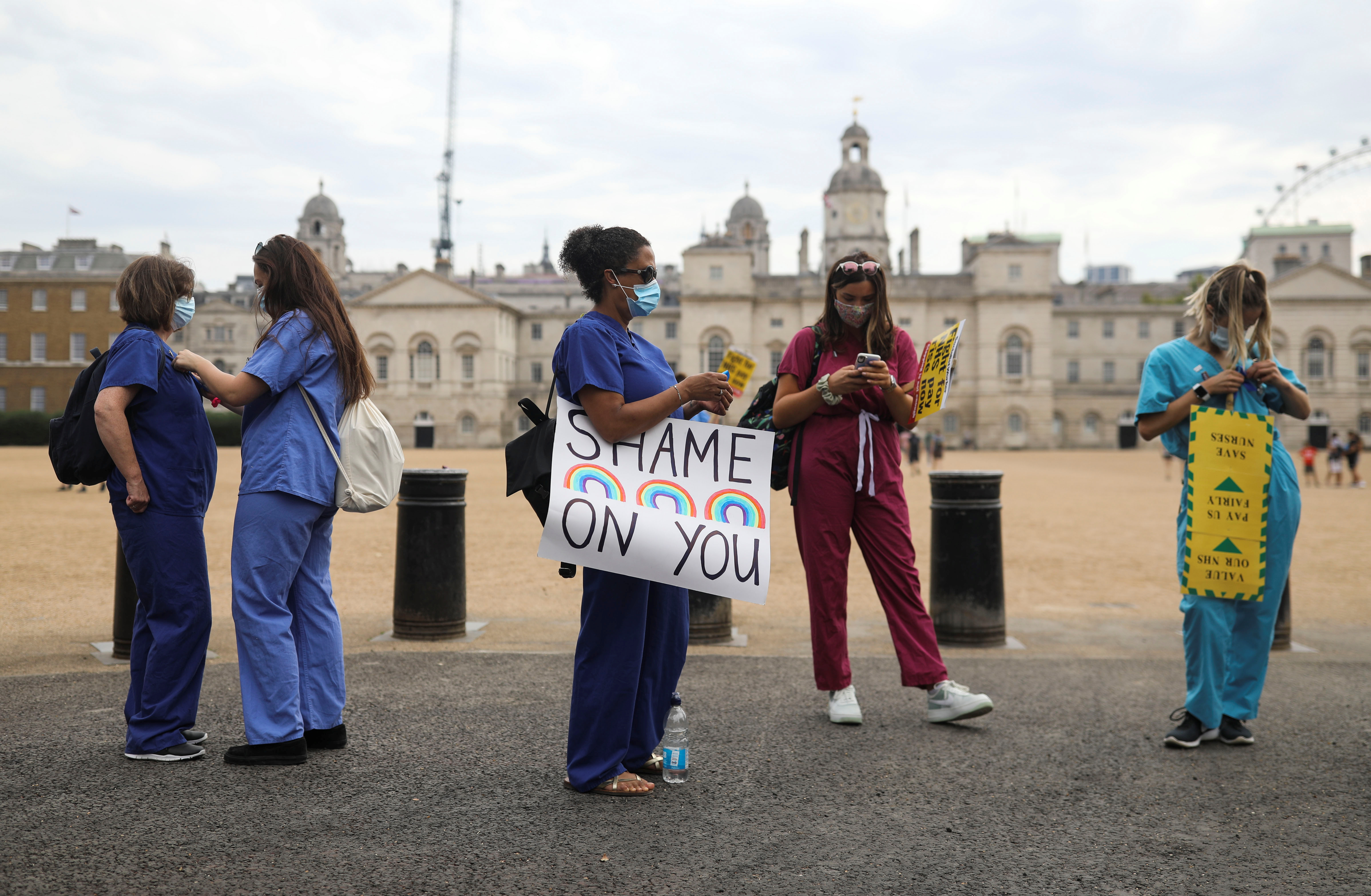 Protesters attend a demonstration of NHS staff, unions and campaigners protesting the government's handling of the coronavirus disease (COVID-19) crisis, in London, Britain, August 8, 2020. REUTERS/Simon Dawson