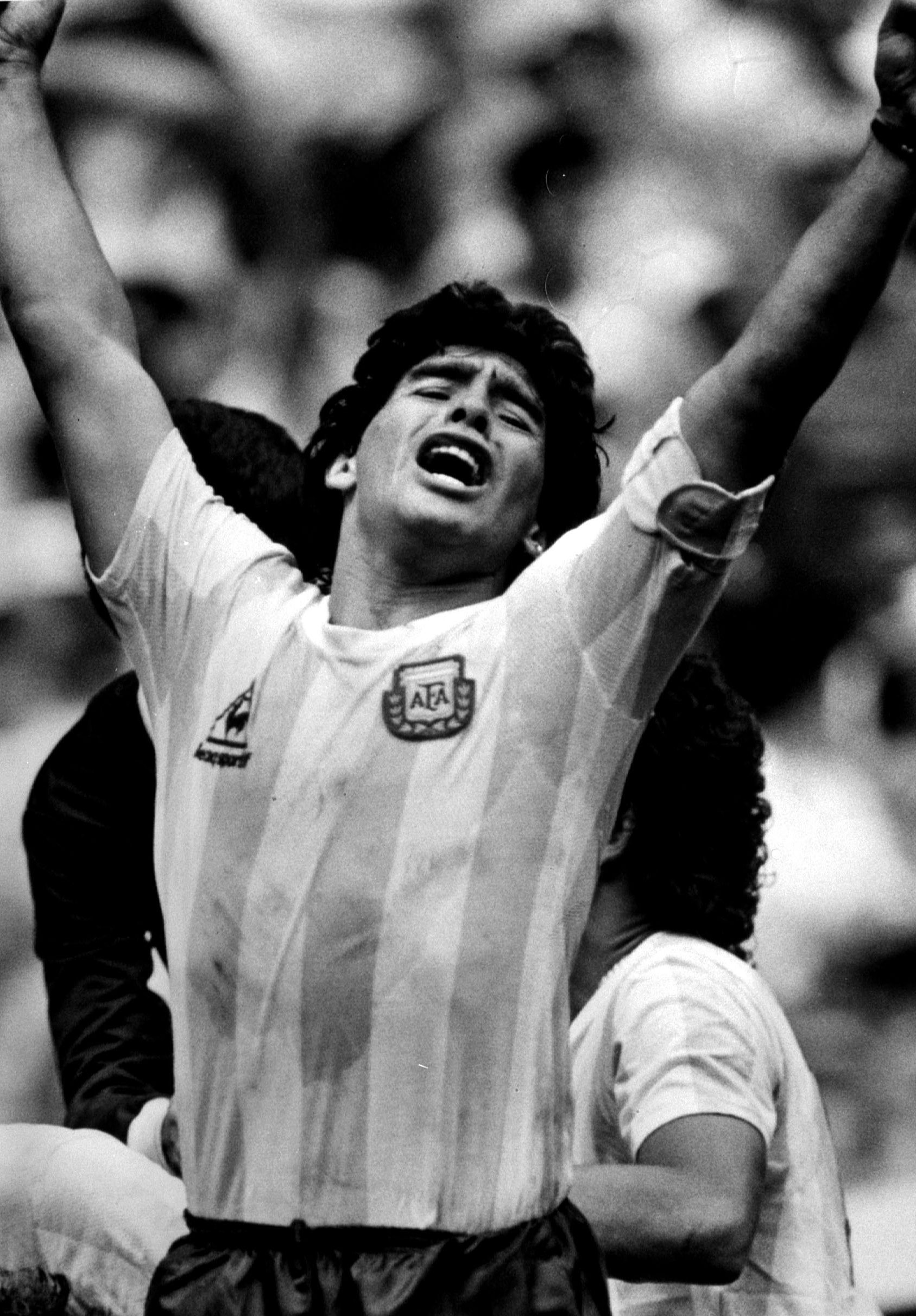 FILE PHOTO:  Argentine star Diego Maradona raises his arms in the air after teammate Jorge Burruchaga scored the winning goal in the second half during the World Cup final in Mexico, June 29, 1994. REUTERS/Stringer/File Photo