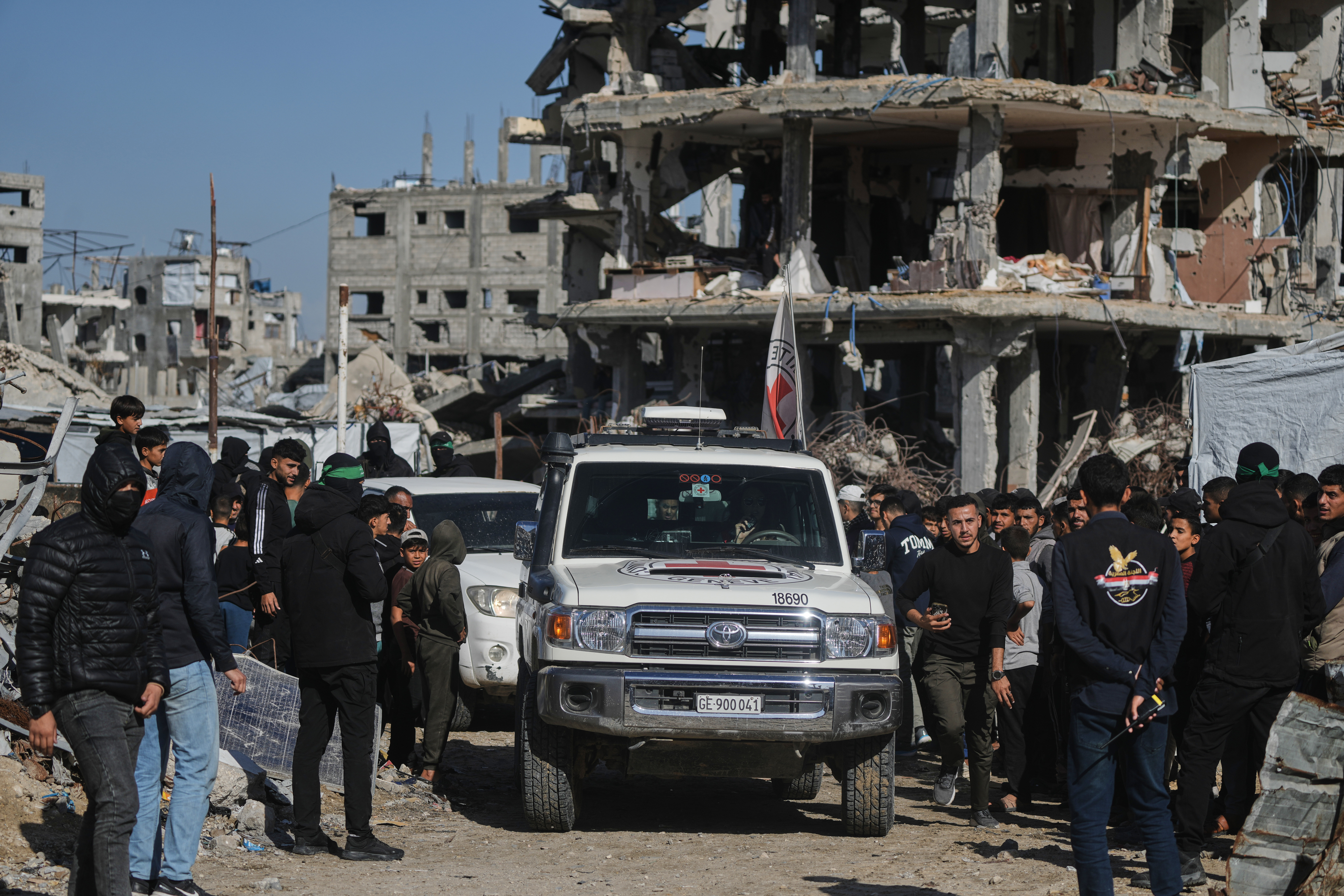 Members of the International Committee of the Red Cross (ICRC) arrive at the site where Hamas militants are searching for the remains of hostages in Jabalia, northern Gaza Strip, Monday, Dec. 1, 2025. (AP Photo/Jehad Alshrafi)