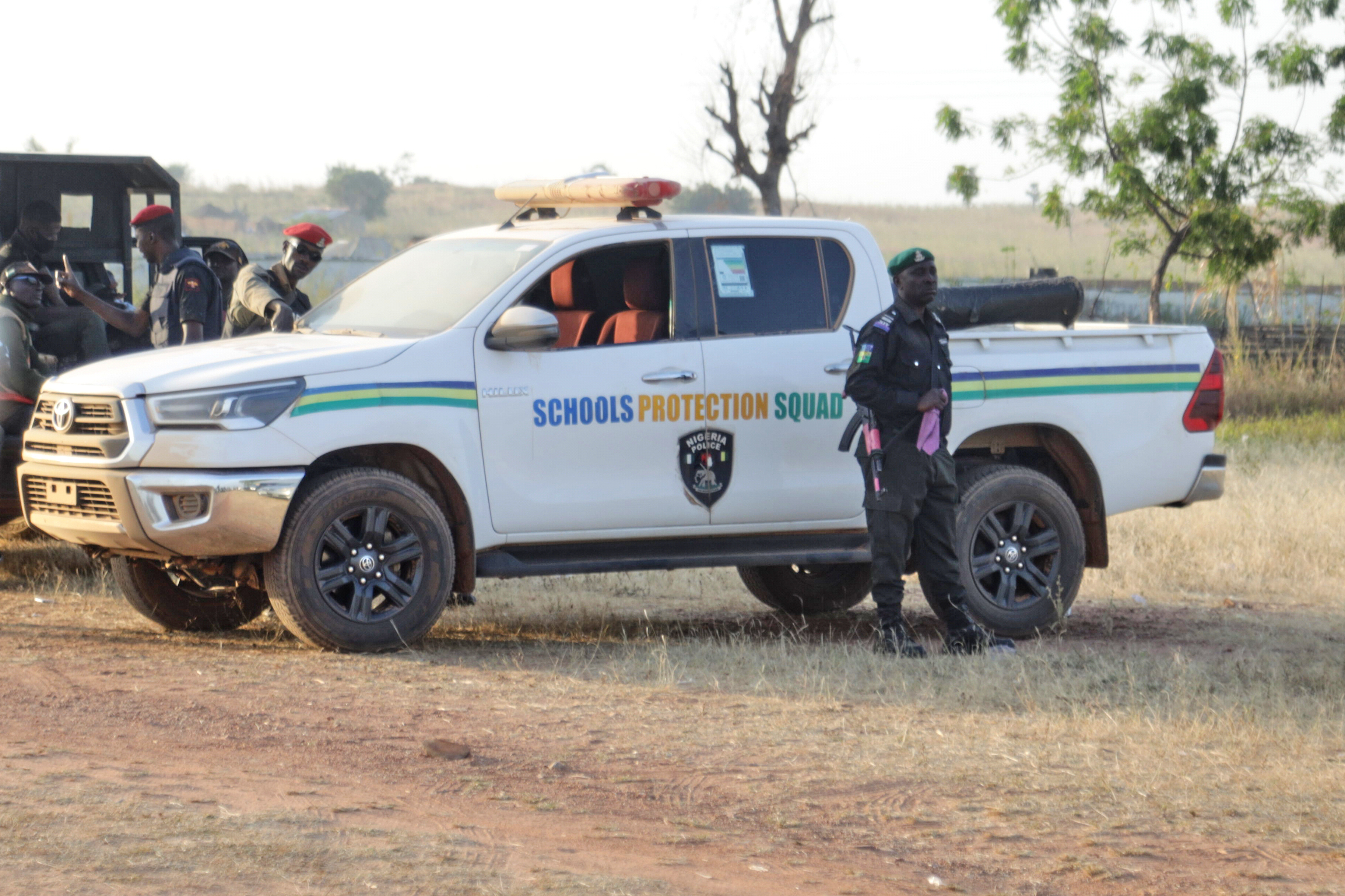 Police officers stand guard outside the school where children were kidnapped by gunmen in Kebbi, Nigeria, Monday, Nov 17, 2025. (AP Photo/Deeni Jibo)
