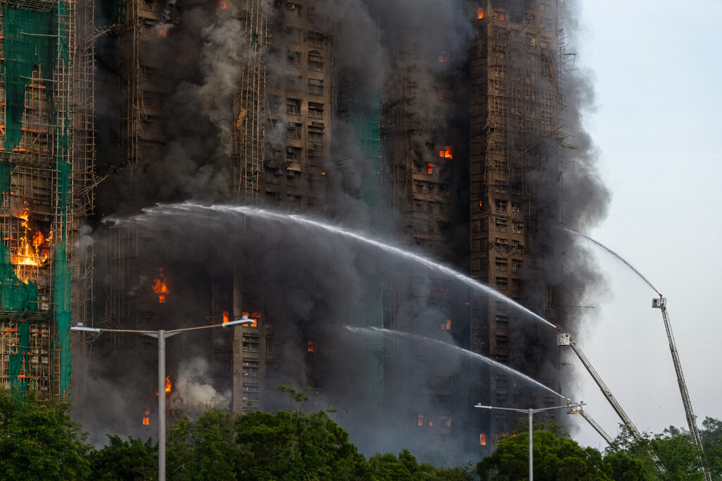 First responders work the scene of a fire at Wang Fuk Court, a residential estate in the Tai Po district of Hong Kong's New Territories on Wednesday, Nov. 26 2025. (AP Photo/Chan Long Hei)