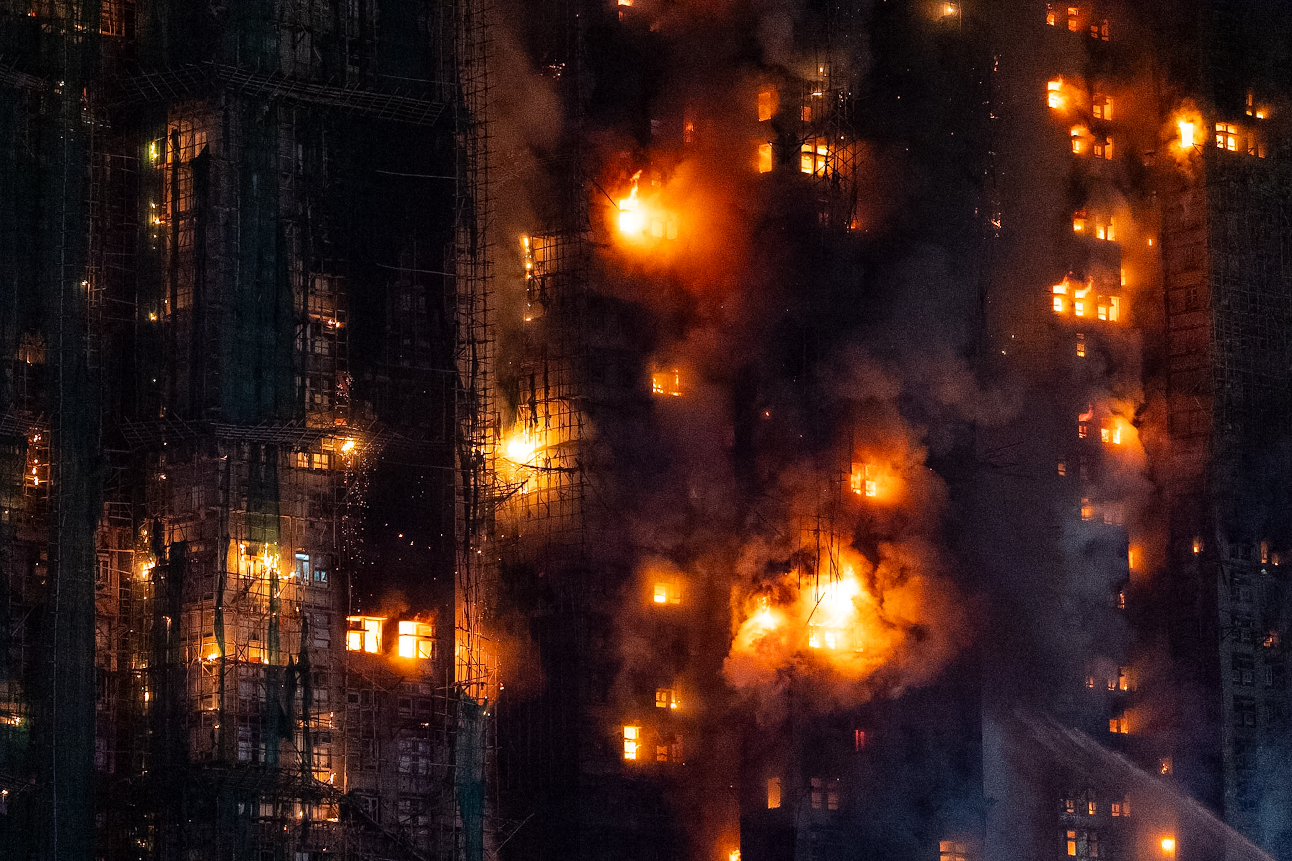 Firefighters work to extinguish a fire which broke out at Wang Fuk Court, a residential estate in the Tai Po district of Hong Kong's New Territories, Wednesday, Nov. 26, 2025. (AP Photo/Chan Long Hei)