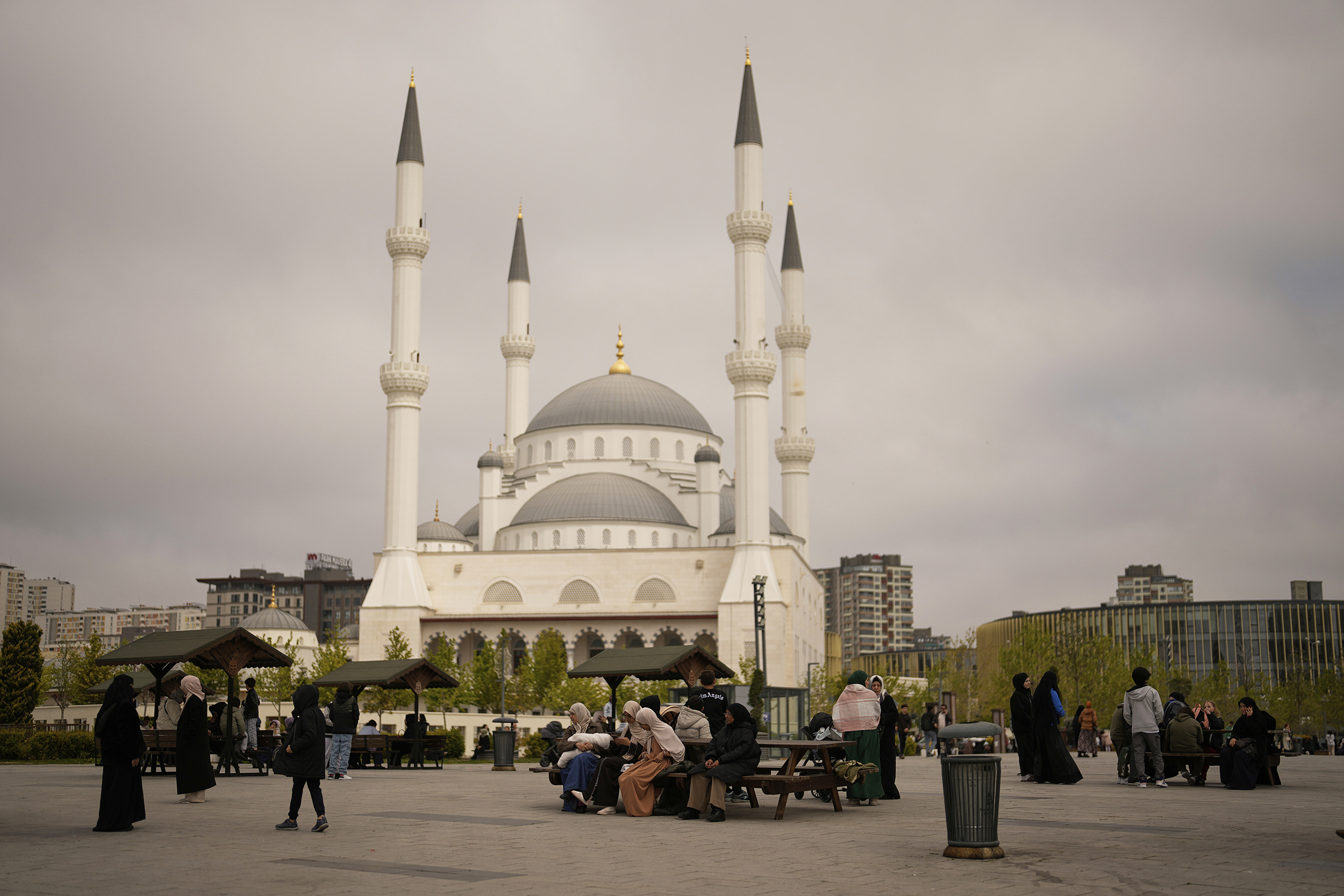 People gather outdoors following an earthquake shock with a preliminary magnitude of 6.2, in Istanbul, Turkey, Wednesday, April 23, 2025. (AP Photo/Khalil Hamra)