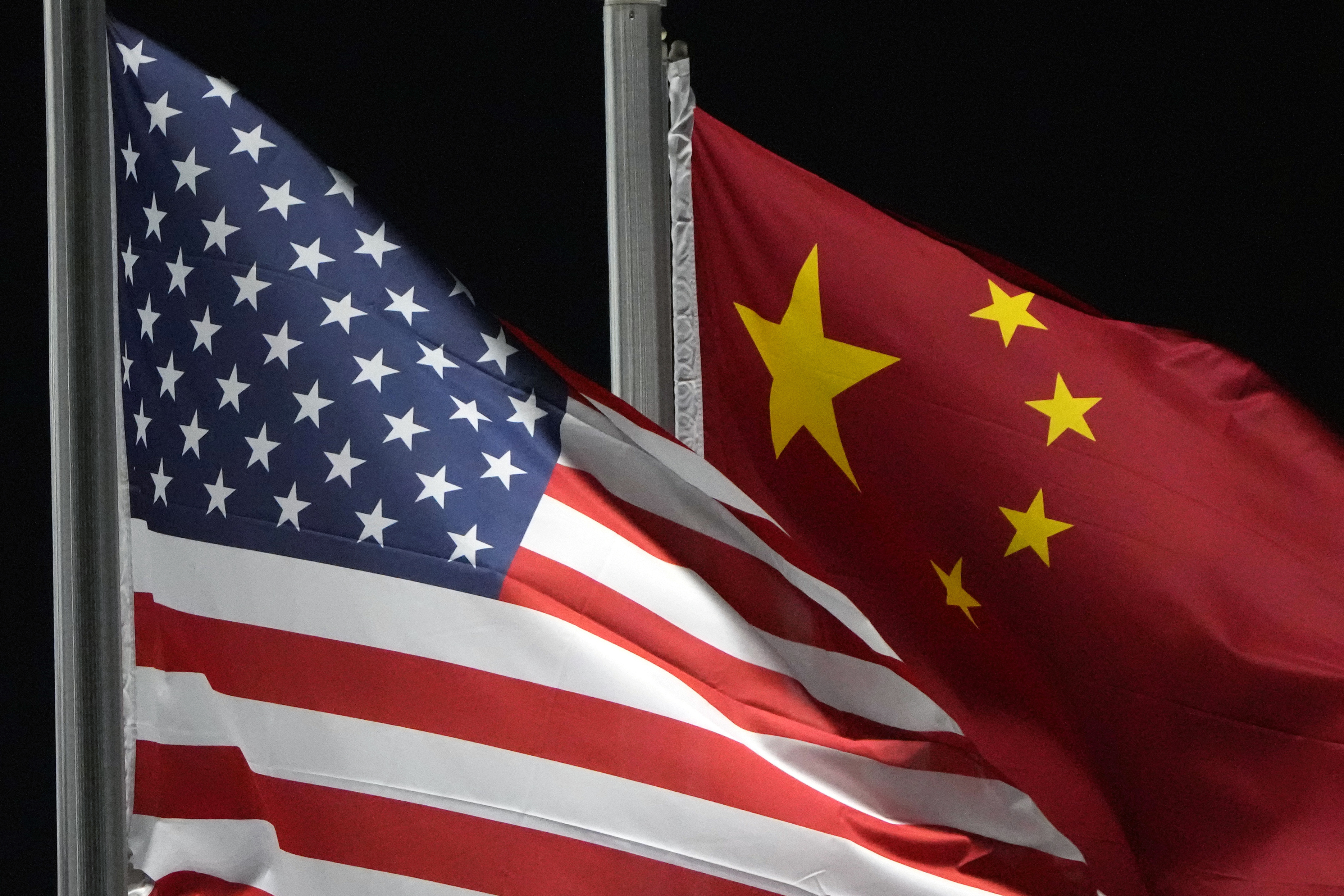 FILE - The American and Chinese flags wave, Feb. 2, 2022, in Zhangjiakou, China. (AP Photo/Kiichiro Sato, File)