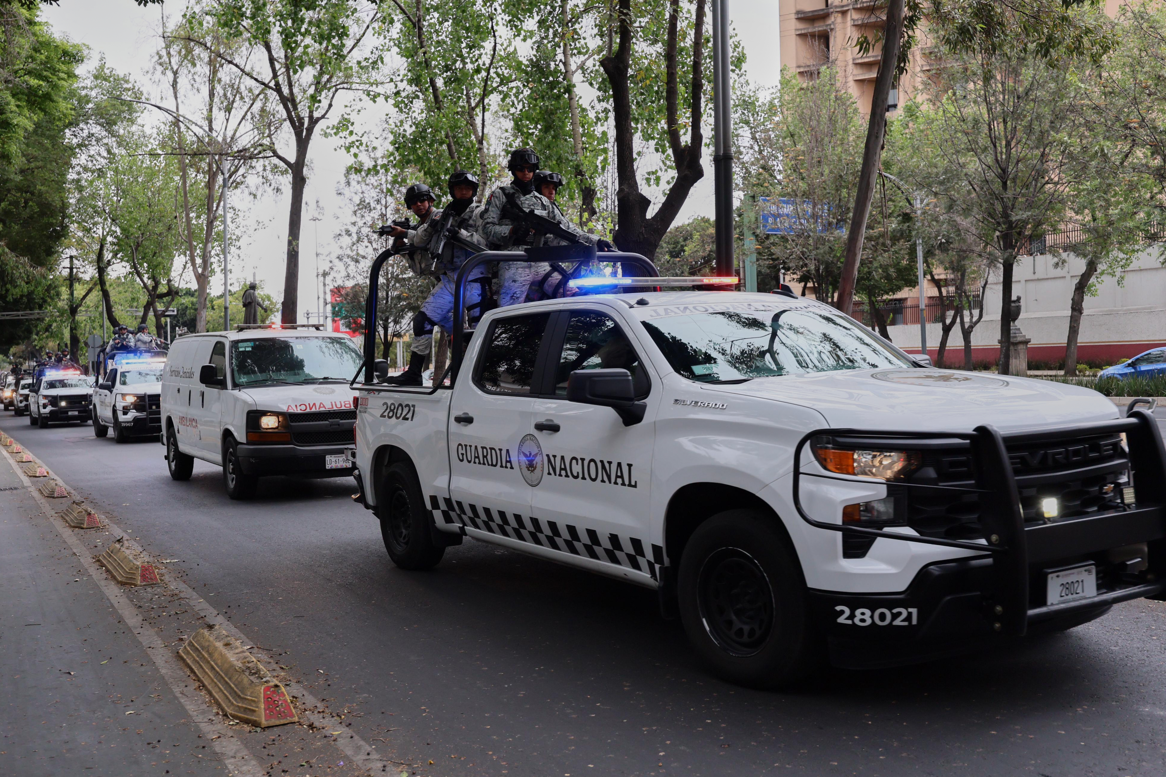 National Guards escort an ambulance to the General Prosecutor's headquarters in Mexico City, Sunday, Feb. 22, 2026, after the death of the leader of the Jalisco New Generation Cartel, Nemesio Rubén Oseguera Cervantes, known as "El Mencho."