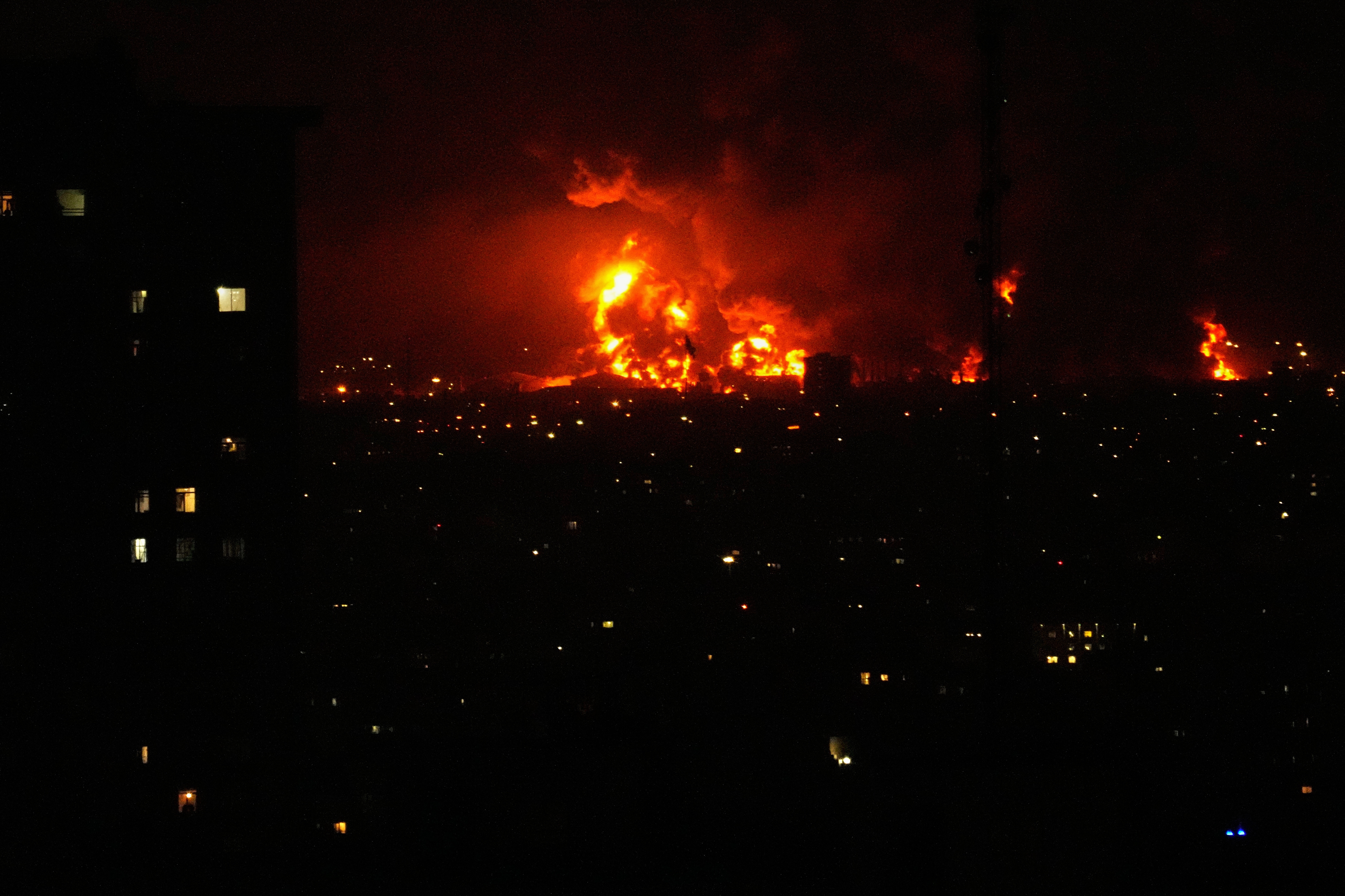 Flames rise from an oil storage facility south of the capital Tehran as strikes hit the city