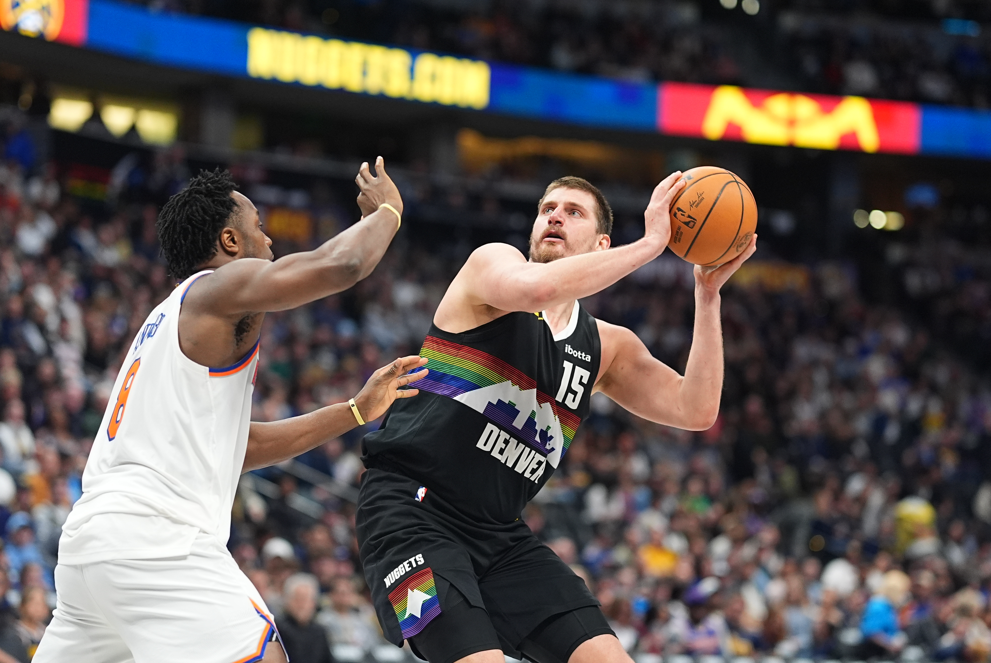 Denver Nuggets center Nikola Jokić, right, shoots for a basket as New York Knicks forward Og Anunoby defends in the second half of an NBA basketball game Friday, March 6, 2026, in Denver. (AP Photo/David Zalubowski)