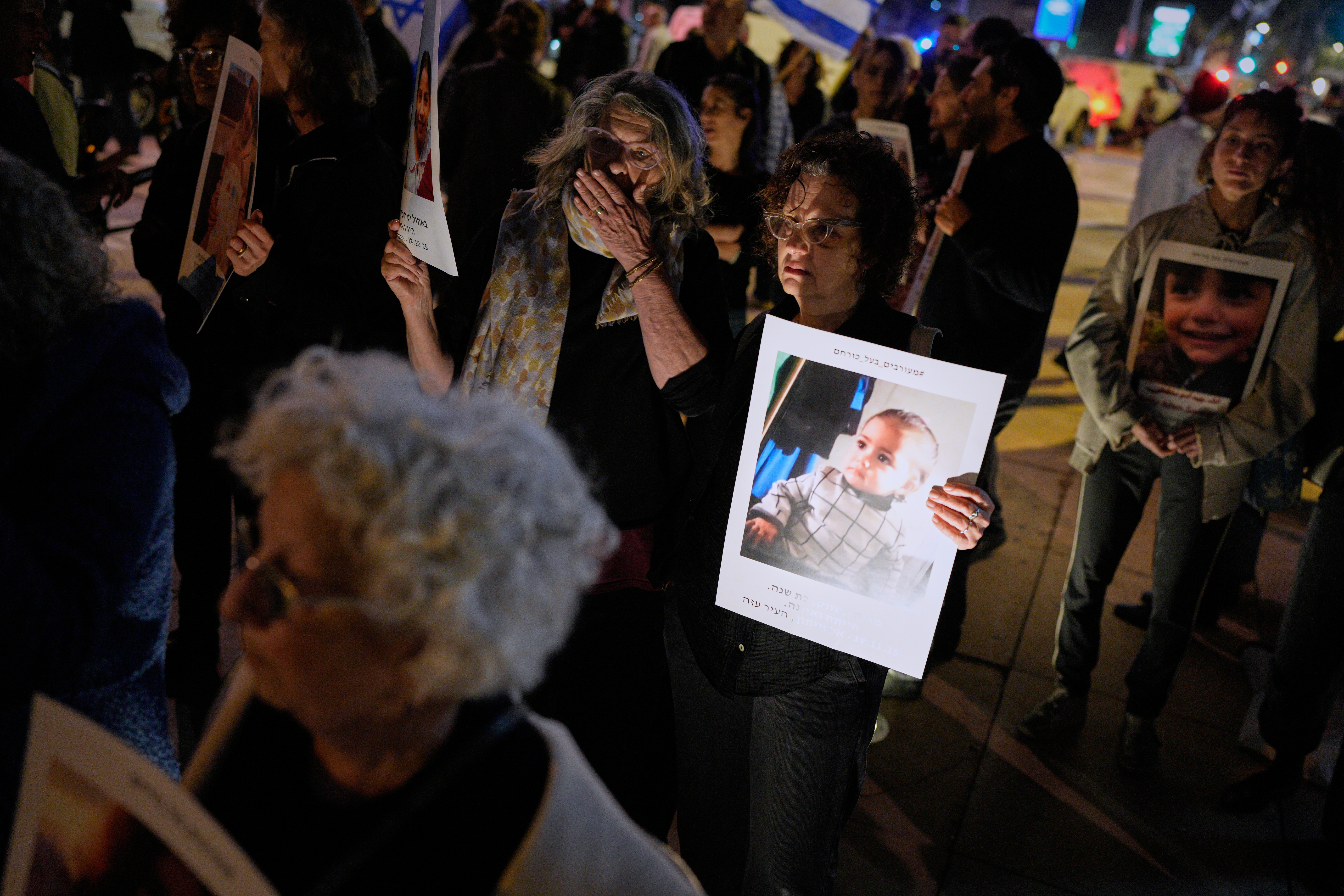 Activists hold photos of children killed across Israel, the Palestinian territories