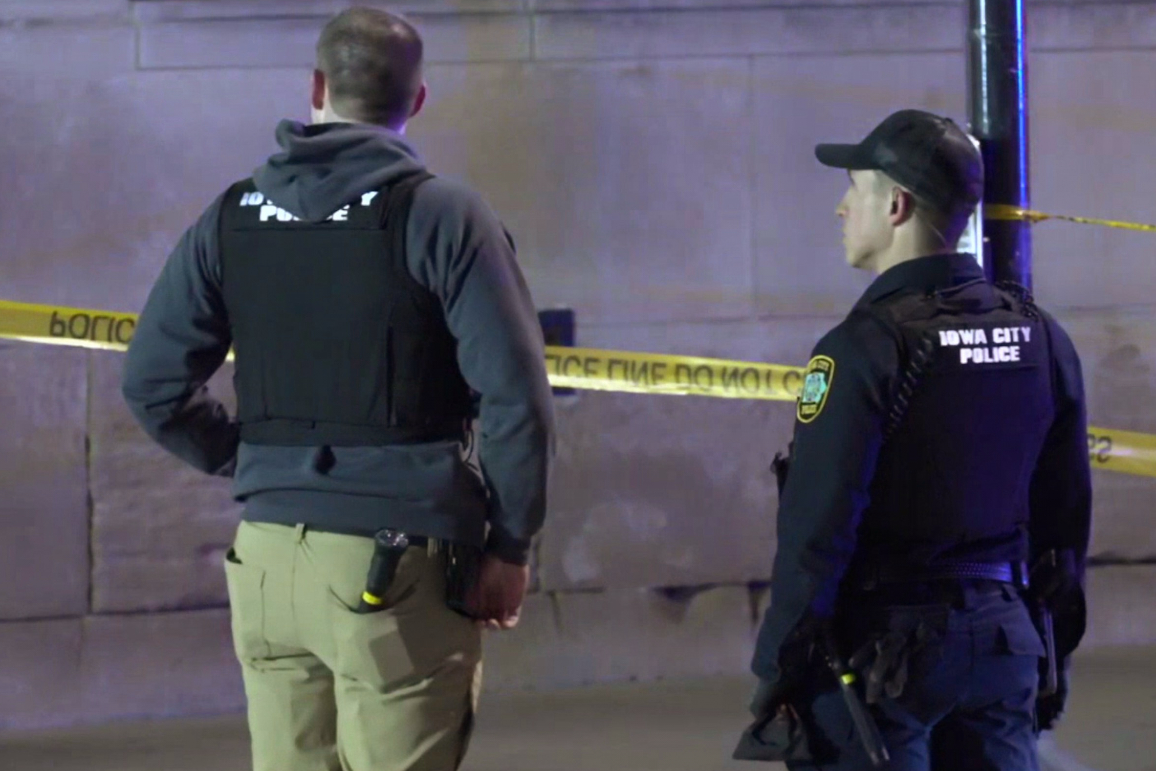 This image made from video provided by KCRG shows Iowa City police officers working the scene of a downtown shooting near the University of Iowa campus on Sunday, April 19, 2026. (KCRG via AP)