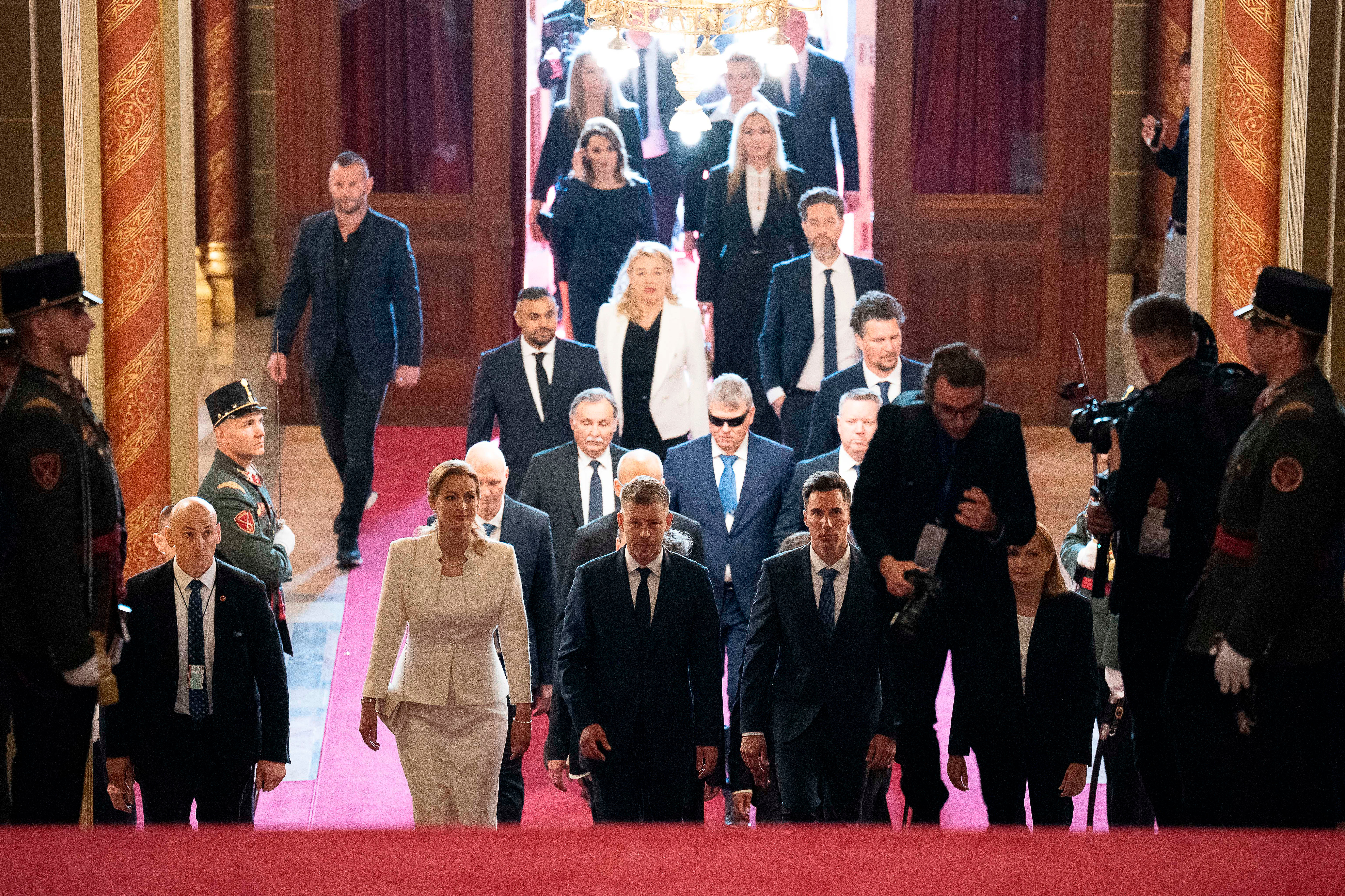 Hungarian Prime Minister-elect Peter Magyar, center, arrives with fellow lawmakers at the Parliament building in Budapest, Hungary, Saturday, May 9, 2026. (AP Photo/Denes Erdos)