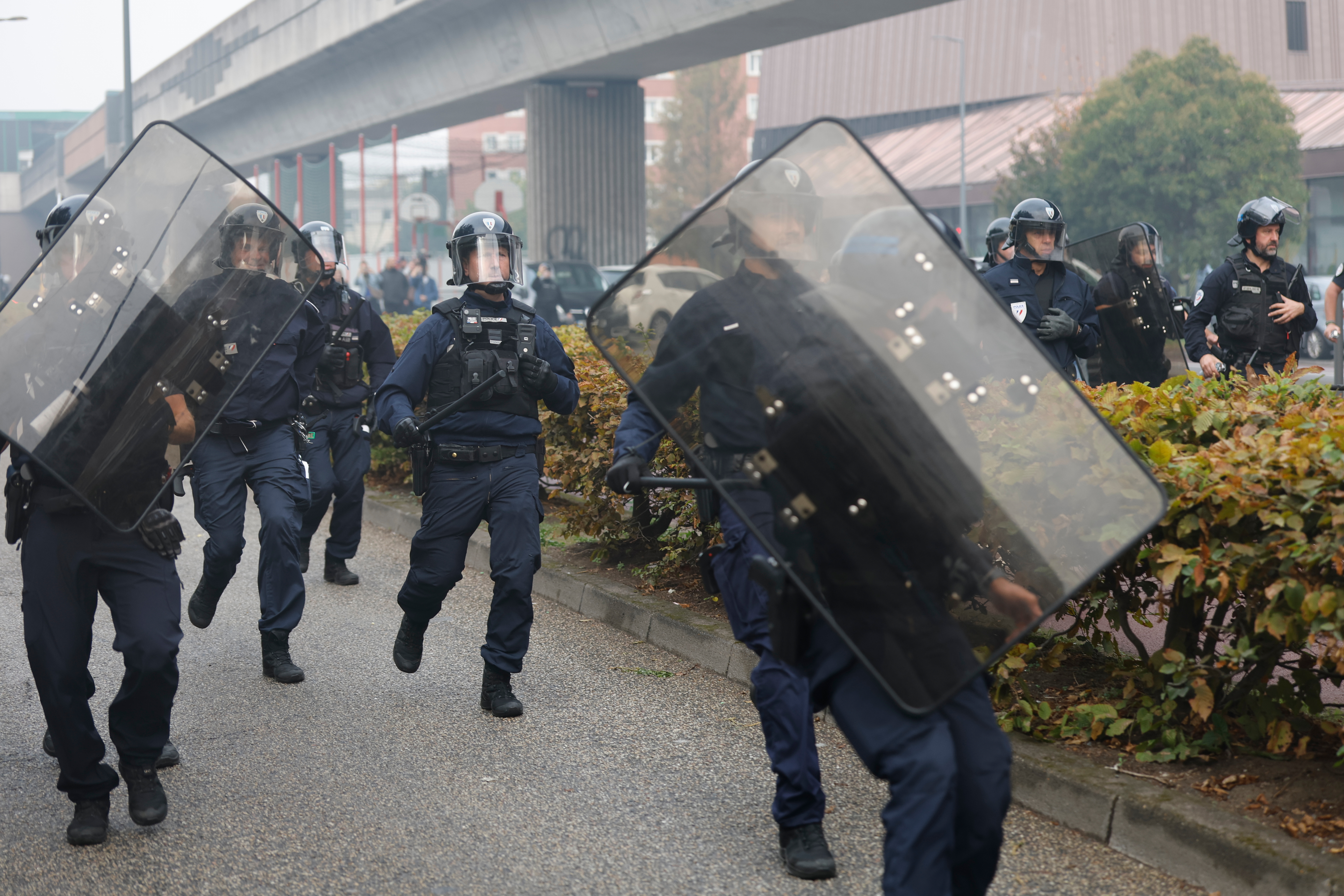 French police face students next to the entrance of Baggio High School, blocked in protest of the government's release of next year's draft budget, in Lille, France, Tuesday, Sept. 29, 2026. (AP Photo/Jean-Francois Badias)