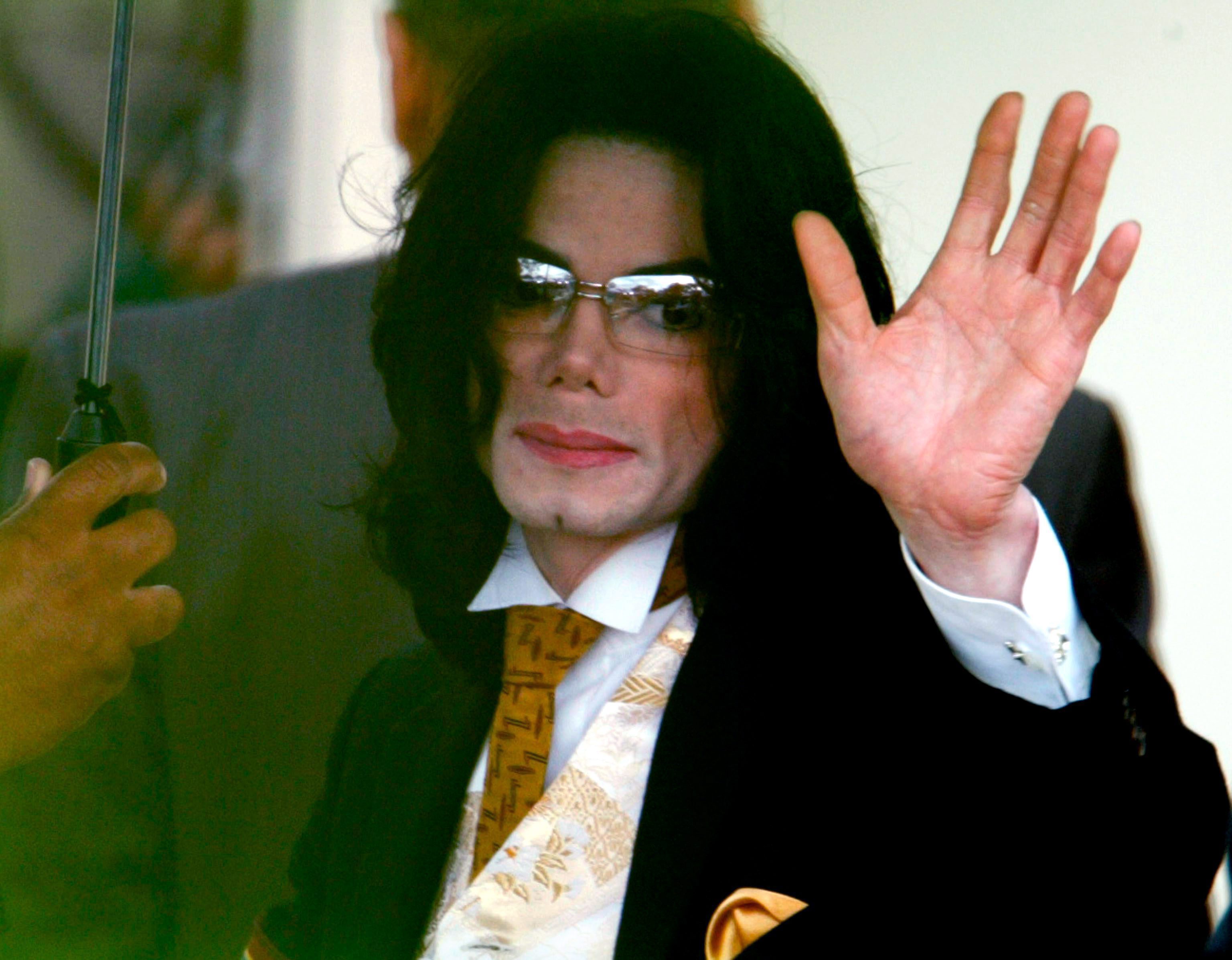US pop star Michael Jackson waves to fans as he arrives at  the Santa Barbara County Superior Court