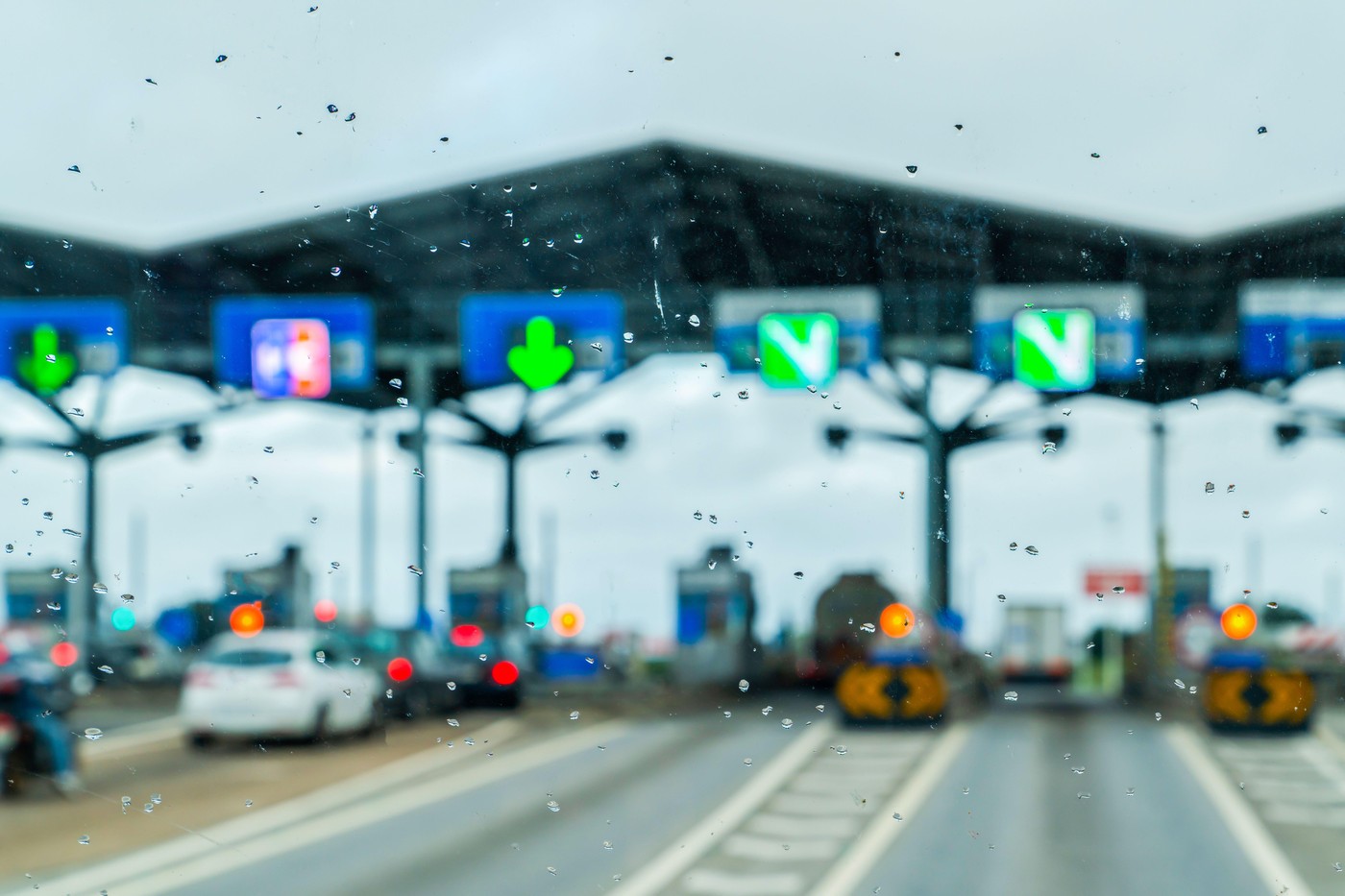 The view of customs checkpoint for cars from inside of the bus in a rainy day. Passport verification and document inspection at border crossing. Check