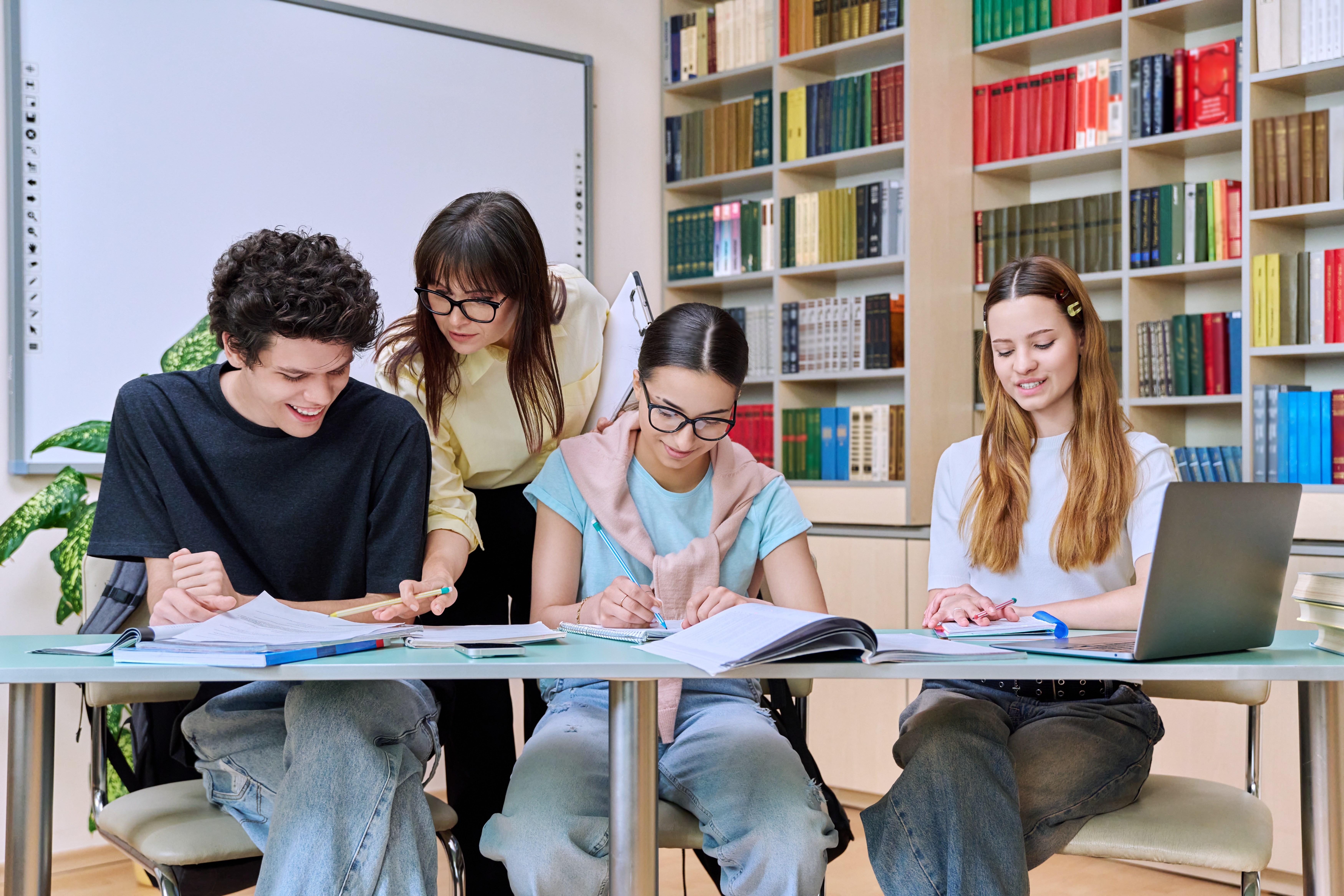 Group,Of,Teenage,Students,With,Female,Teacher,Study,Inside,Classroom
