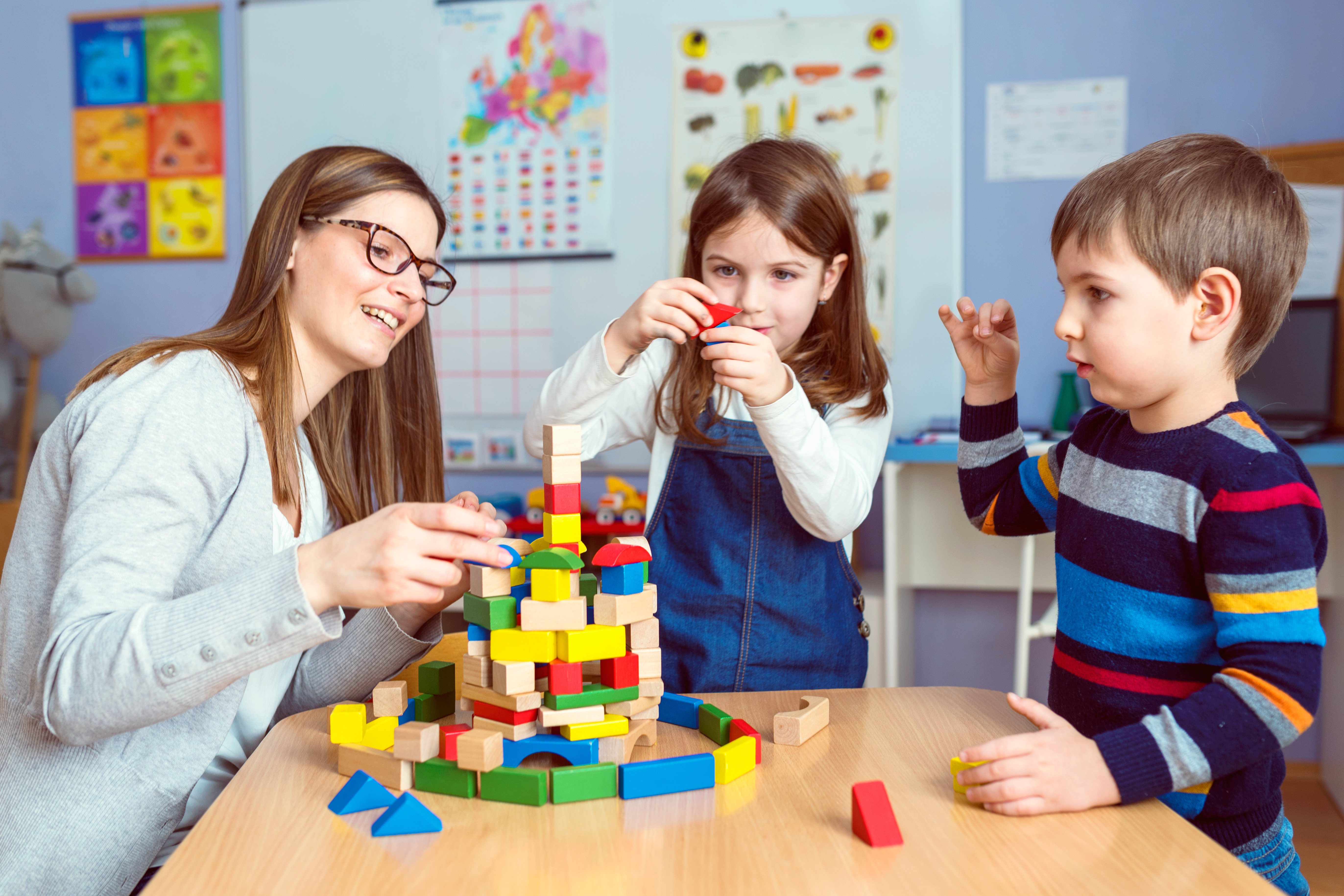 Teacher,And,Kids,Playing,Together,With,Colorful,Toy,Building,Blocks