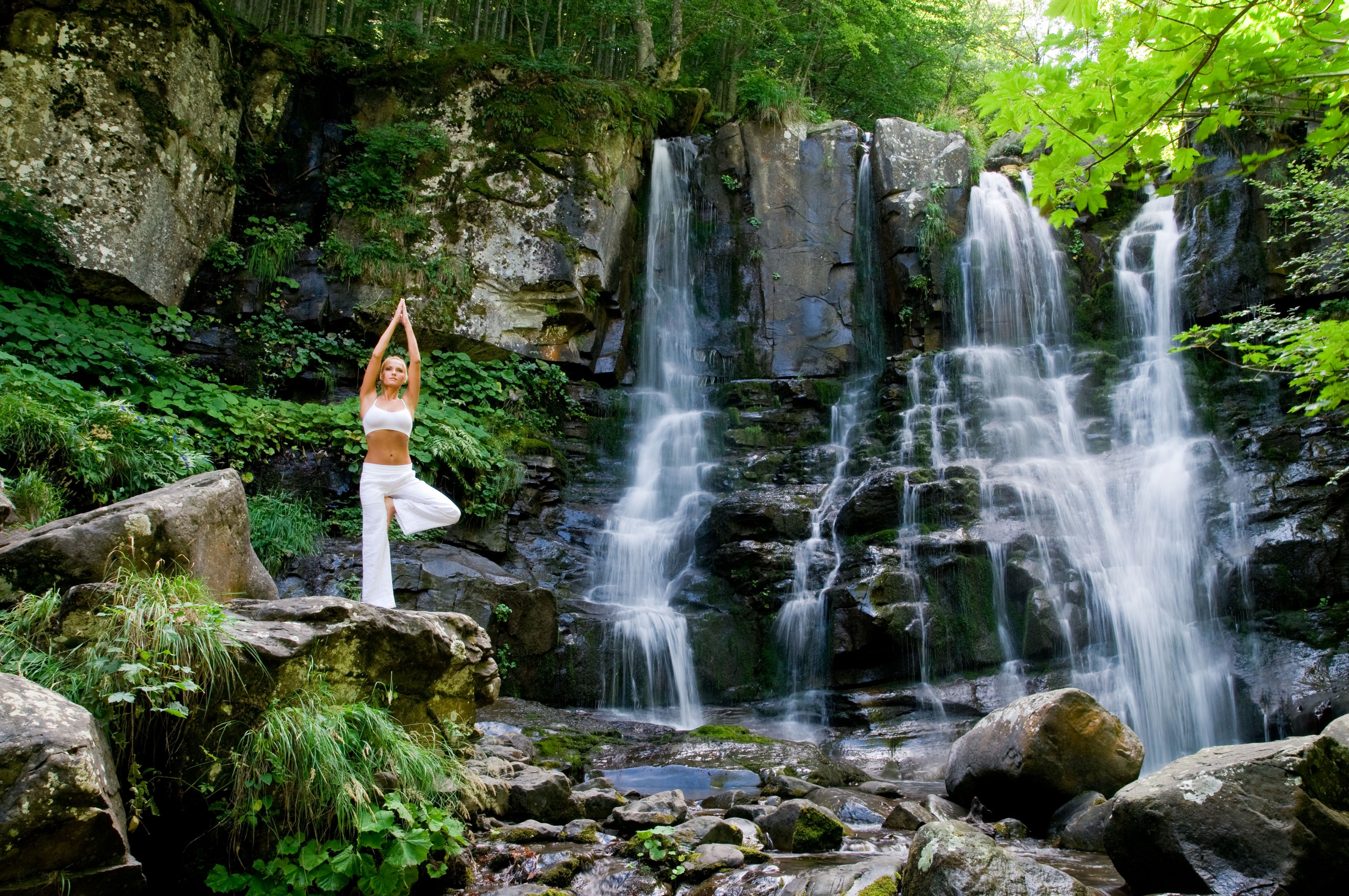 Beautiful young woman meditating while doing yoga in a wonderful forest near waterfall,Image: 50963061, License: Rights-managed, Restrictions: , Model Release: yes, Credit line: Francesco Ridolfi / Alamy / Profimedia