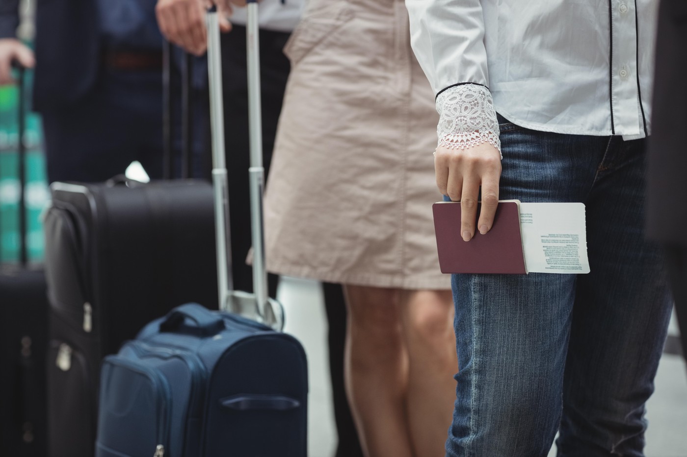 Passengers holding passports and boarding pass waiting in queue inside the airport terminal,Image: 318022416, License: Royalty-free, Restrictions: , Model Release: yes, Credit line: Wavebreak Media Premium / Alamy / Alamy / Profimedia
