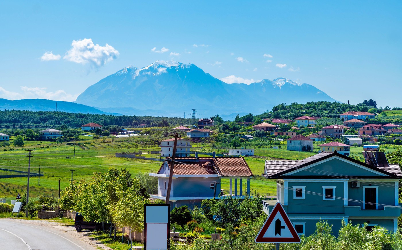A view approaching  a village in Albasan county near Belsh Lakes, Albania in summertime