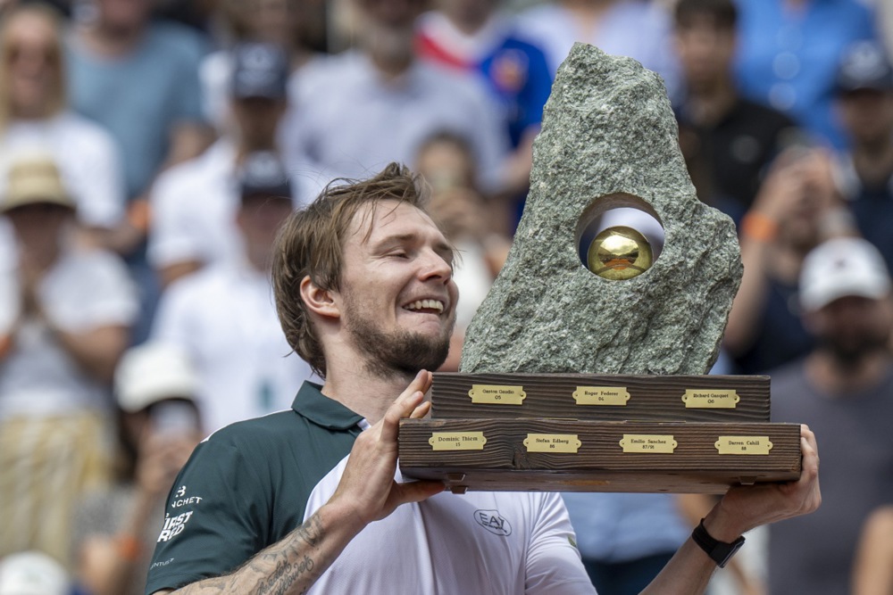 epa12249328 Alexander Bublik of Kazhakztan, winner, celebrates with the trophy after the final game against Manuel Cerundolo of Argentina at the Swiss Open tennis tournament in Gstaad, Switzerland, 20 July 2025.  EPA/PETER SCHNEIDER