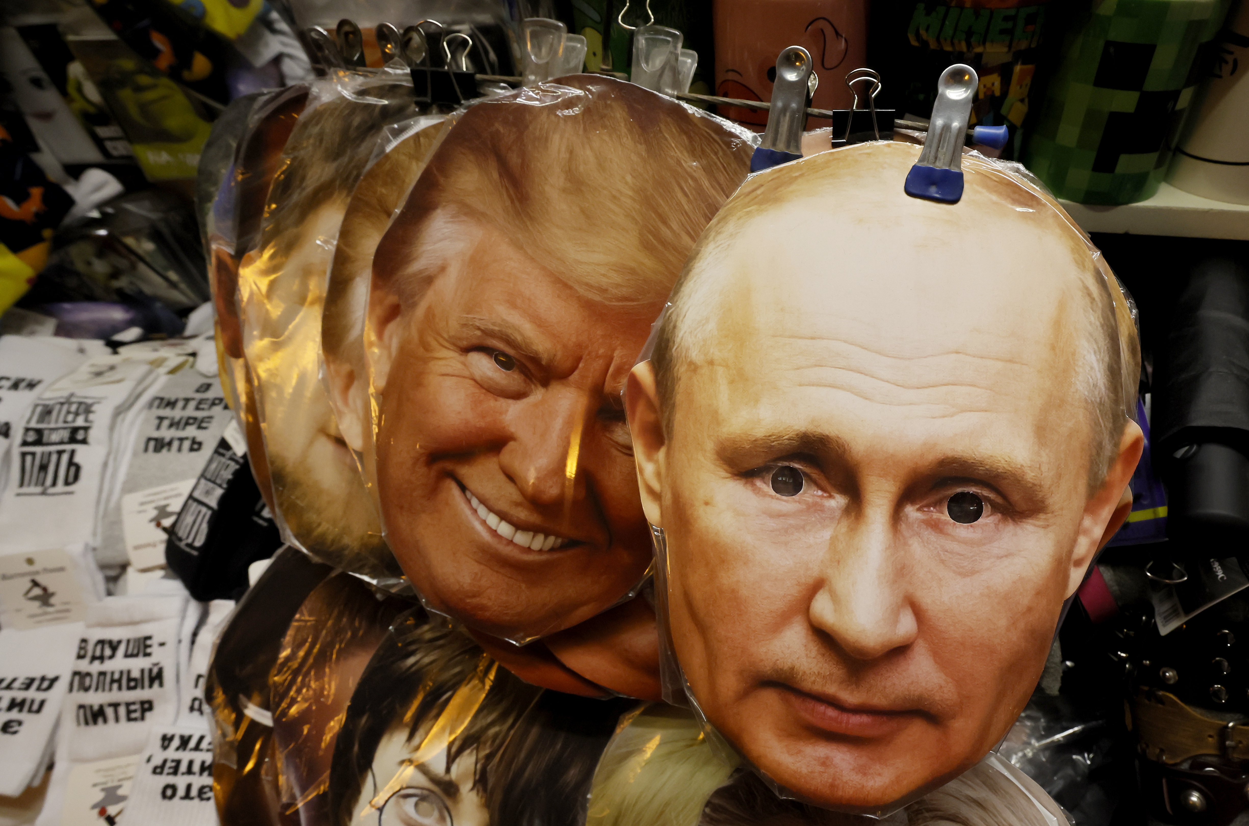 epa12288080 Face masks depicting U.S. President Donald J. Trump (L) and Russian President Vladimir Putin (R) are displayed for sale at a souvenir market in St. Petersburg, Russia, 07 August 2025.   EPA/ANATOLY MALTSEV