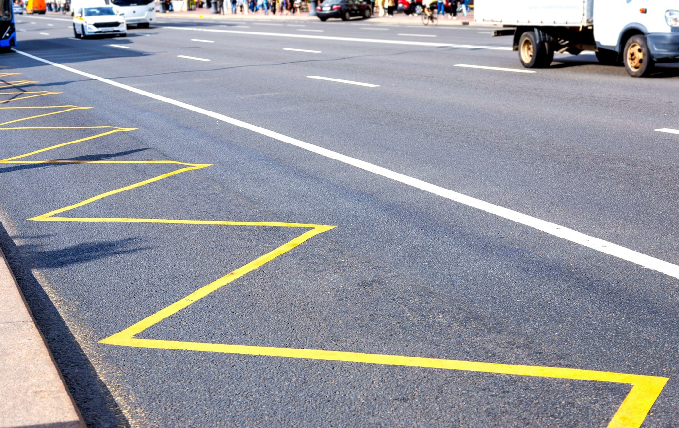 Road markings of a city street for public transport stops in summer