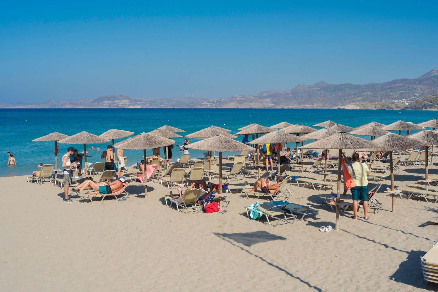 Sitia Beach, view in summer of people sunbathing on the beach in Sitia Bay, Crete, Greece, Europe
