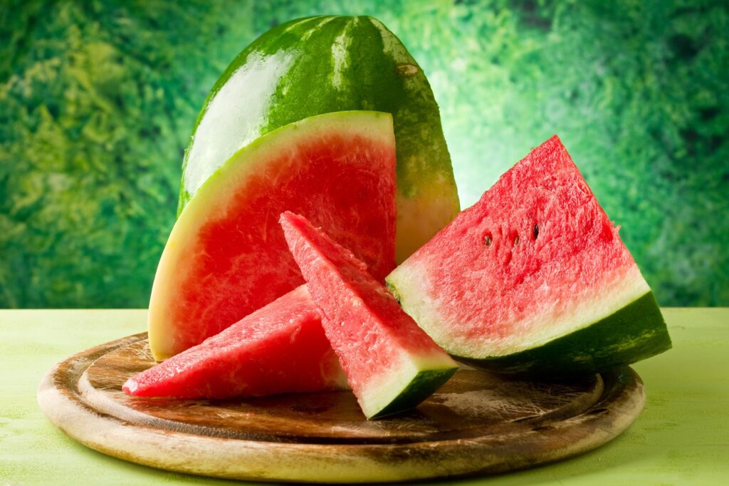 photo of fresh delicious watermelon on chopping board with green background,Image: 168717337, License: Royalty-free, Restrictions: , Model Release: no, Credit line: Francesco Dibartolo / Panthermedia / Profimedia