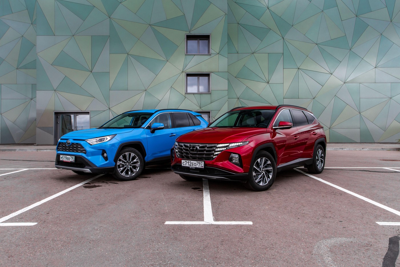 MOSCOW, RUSSIA - SEPTEMBER 9, 2021 New Hyundai Tucson Fourth generation (NX4), and Toyota RAV4 (XA50), a compact crossover SUV car model year 2021 on