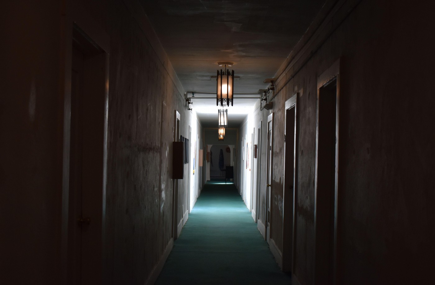 Interior of a dark corridor with light coming from the end.