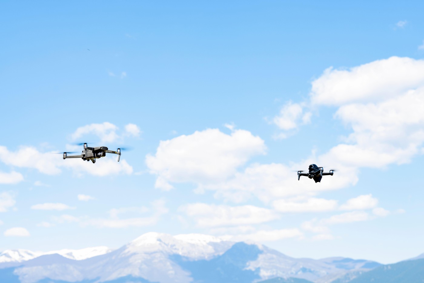 Two Dji drones are flying nearby during a sunny day. DJI FPV is a groundbreaking ready-to-fly FPV drone.