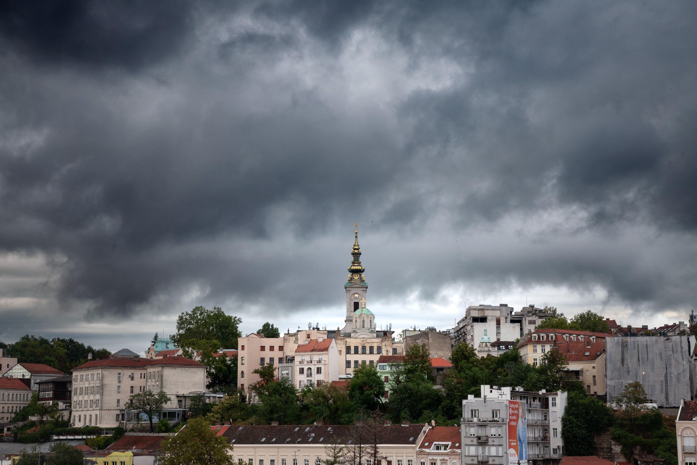 Picture of the Belgrade Cathedral, also known as Saborna Crkva, seen from a nearby street of the Stari Grad district, with 19th century old buildings.
