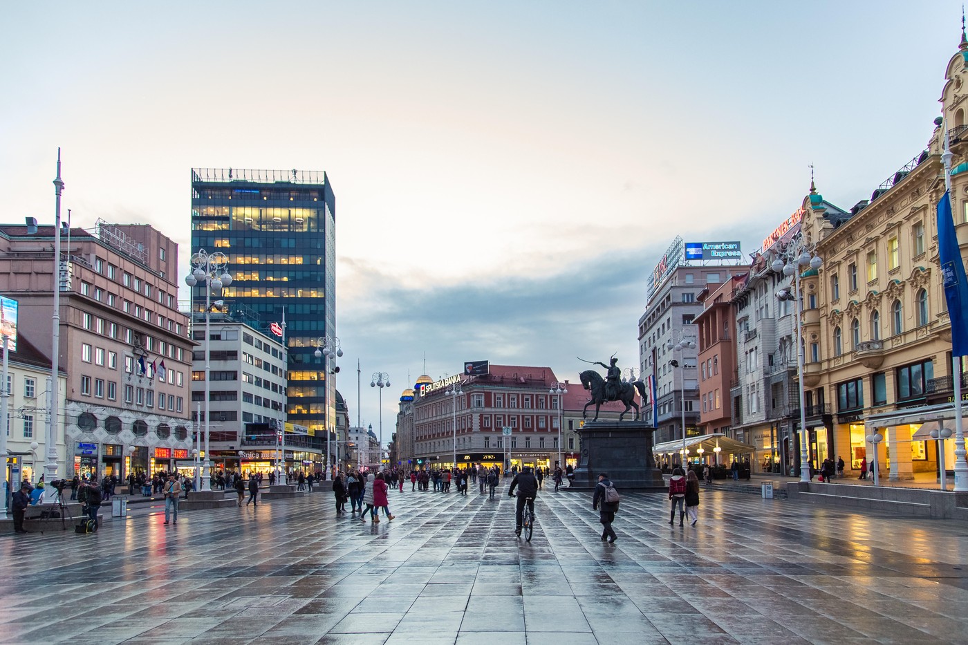 ZAGREB, CROATIA - 11 MARCH 2015: Zagreb's main square with Ban Josip Jelacic statue and surrounding buildings on a wet evening.