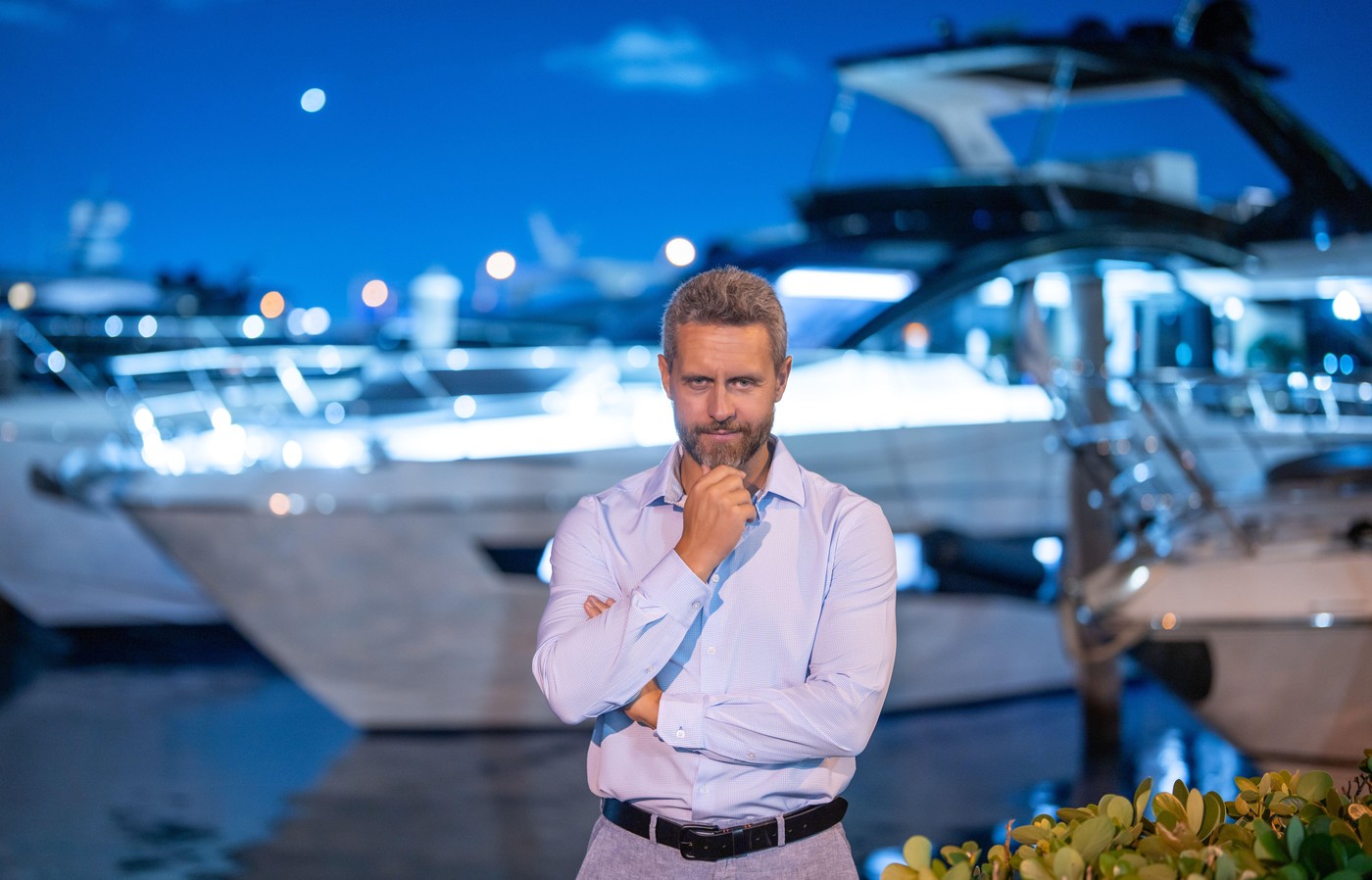 Rich businessman near yacht. Wealthy man enjoying luxury yacht. Millionaire or Billionaire lifestyle. Rich man on a private yacht. Financial freedom.