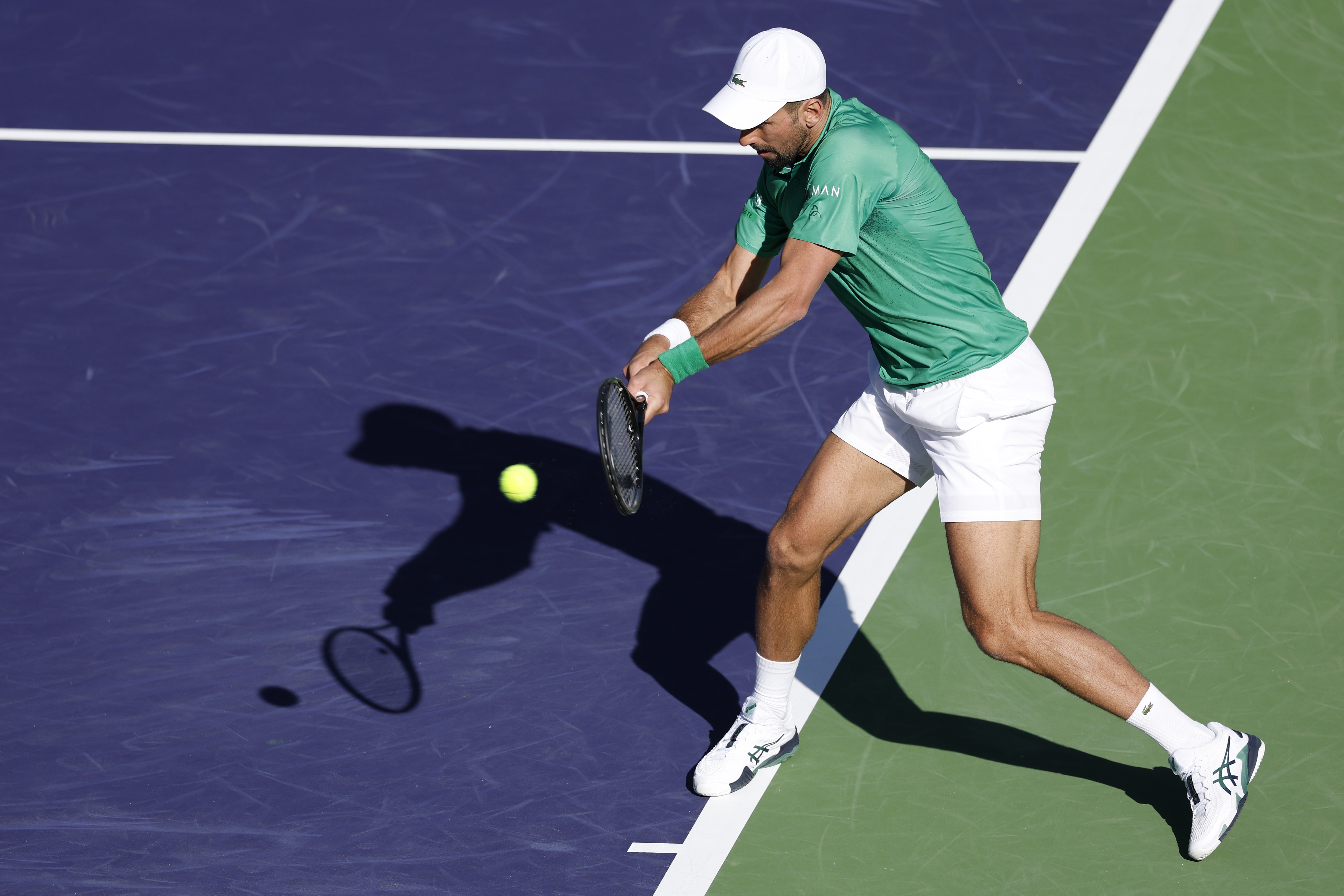 epa11950436 Novak Djokovic of Serbia in action against Botic Van de Zandschulp of the Netherlands during their men's second round match at the BNP Paribas Open tennis tournament in Indian Wells, California, USA, 08 March 2025.  EPA-EFE/JOHN G. MABANGLO