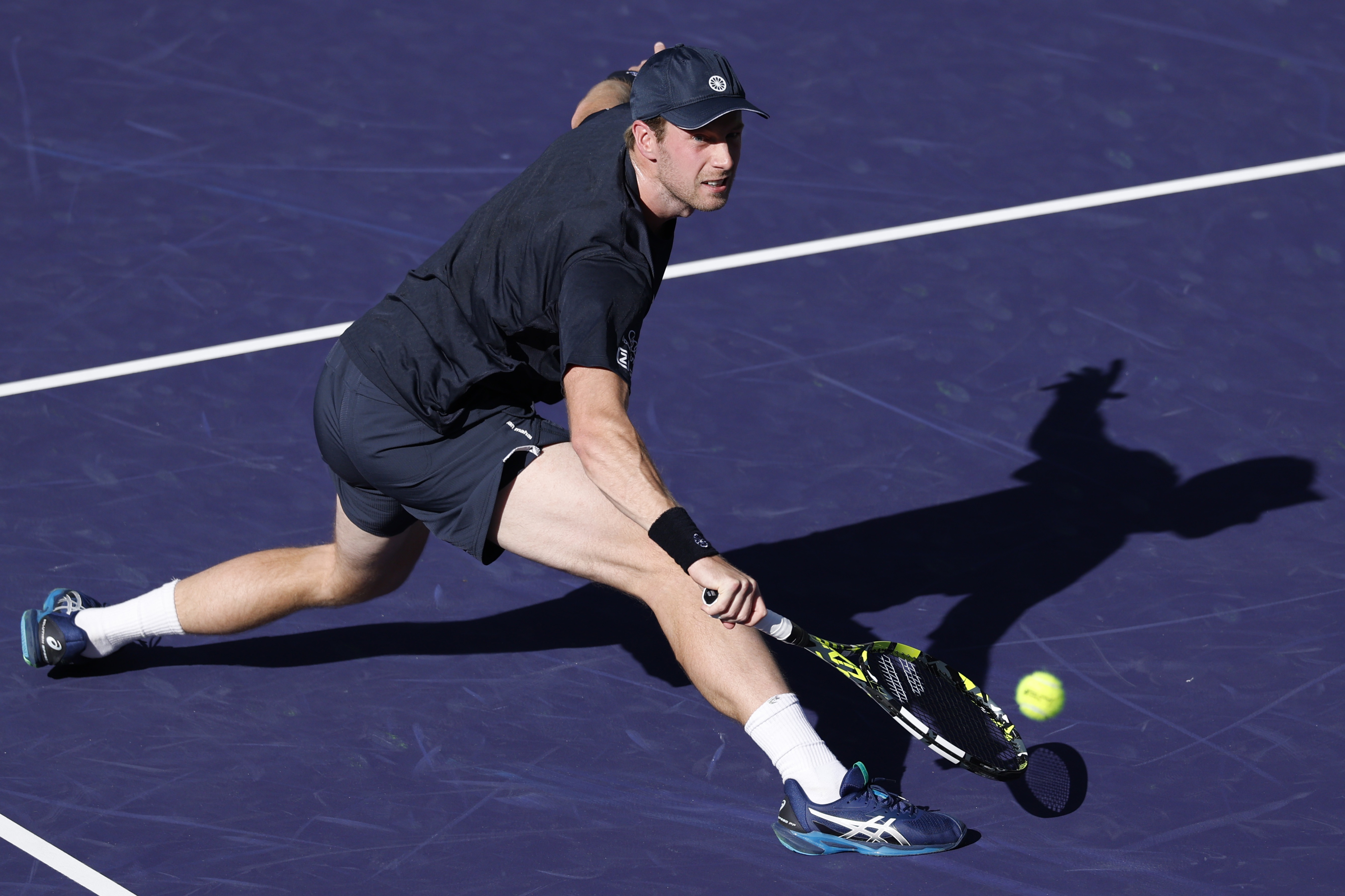 epa11950475 Botic Van de Zandschulp of the Netherlands in action against Novak Djokovic of Serbia during their men's second round match at the BNP Paribas Open tennis tournament in Indian Wells, California, USA, 08 March 2025.  EPA-EFE/JOHN G. MABANGLO