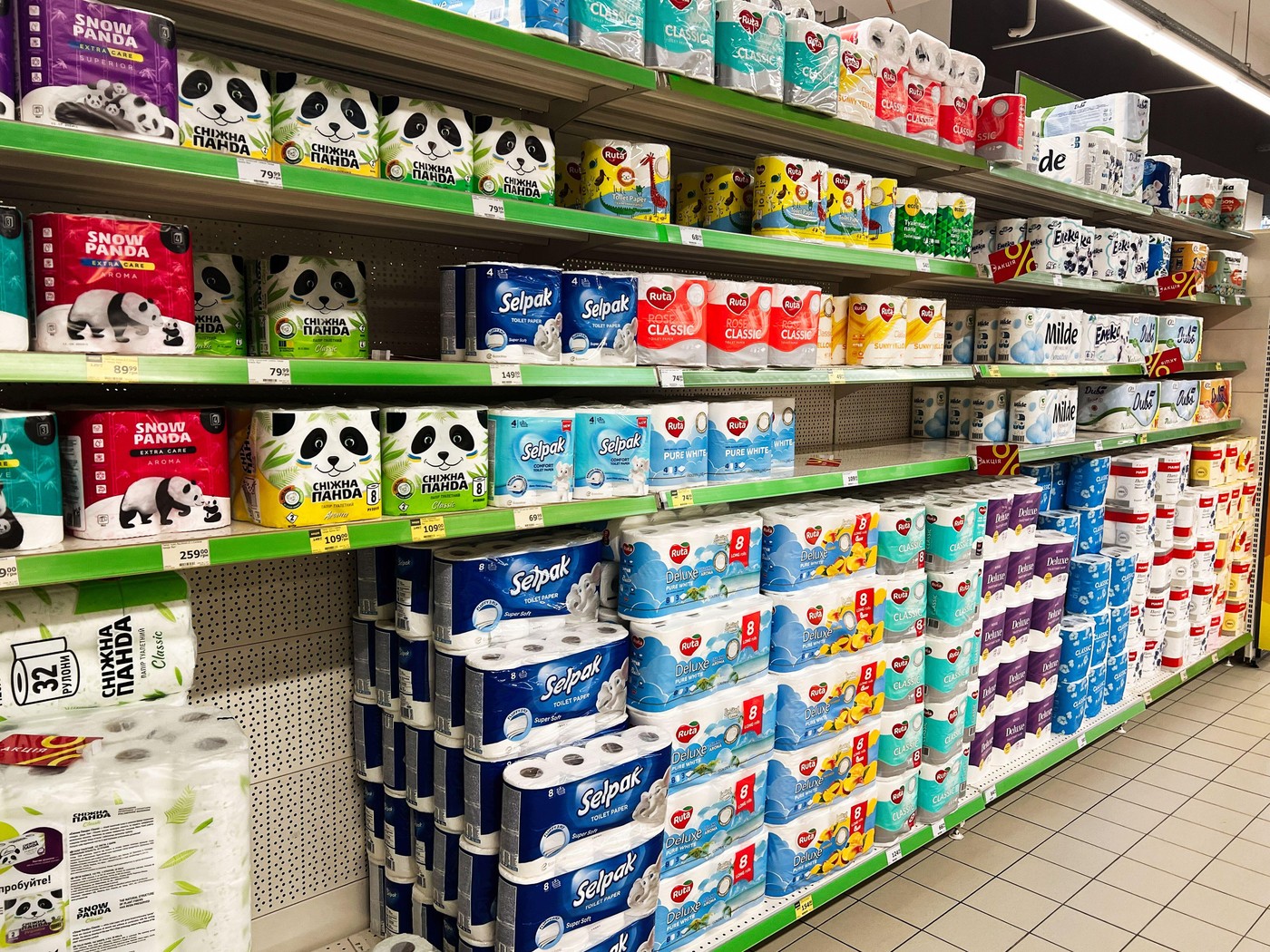 Kyiv, Ukraine - February 04, 2025: Different types of bathroom tissue neatly arranged for sale on supermarket shelves.