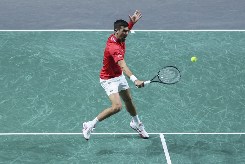 epa10994512 Novak Djokovic of Serbia in action against Jannik Sinner of Italy during their 2023 Davis Cup Final 8 semifinals Italy vs Serbia singles match in Malaga, Spain, 25 November 2023.  EPA-EFE/Daniel Pérez
