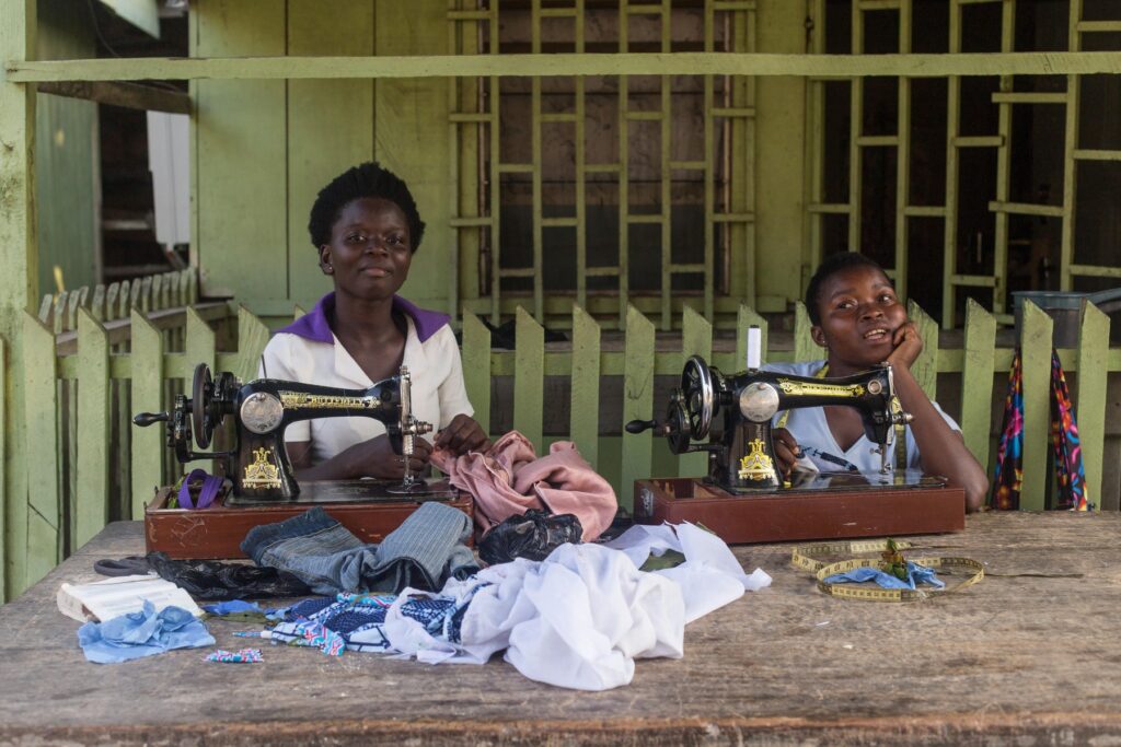 women making clothes with sewing machines on front porch of their house in ghana,Image: 998837139, License: Rights-managed, Restrictions: , Model Release: no, Credit line: Jennika Argent / Alamy / Profimedia