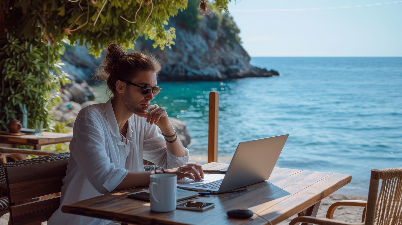 Casual work-from-home environment set against a captivating beach scene,  symbolizing remote work freedom,Image: 845222019, License: Royalty-free, Restrictions: , Model Release: no, Credit line: Sergiy Artsaba / Panthermedia / Profimedia