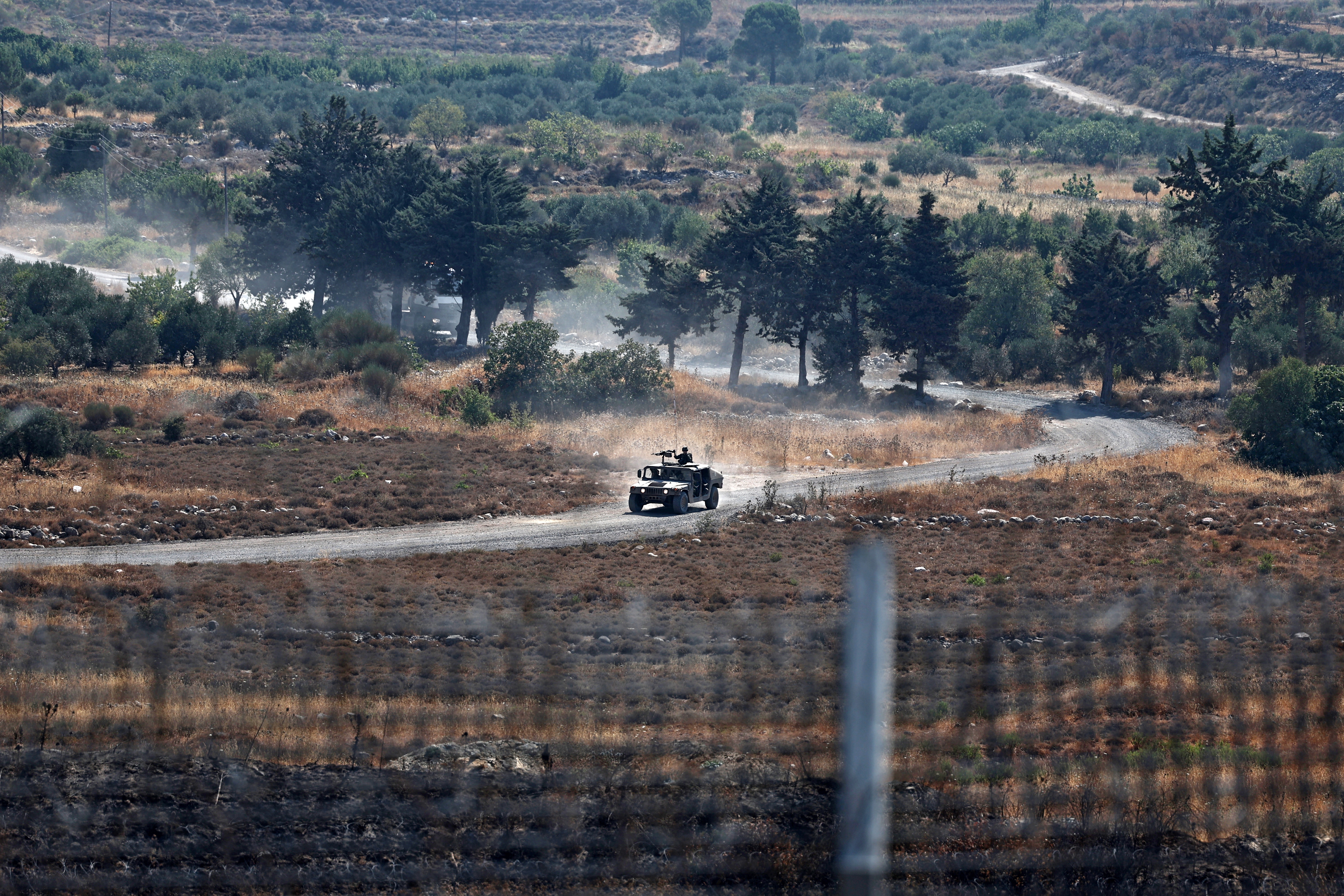 epa12252590 Israeli soldiers patrolling at the ceasefire line, near the Israeli-annexed Golan Heights village of Majdal Shams, 22 July 2025.  EPA/ATEF SAFADI