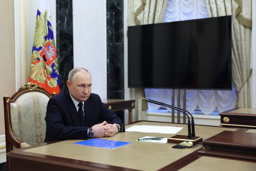 Russian President Vladimir Putin listens to Russian Transport Minister Vitaly Savelyev during their meeting in Moscow, Russia, Saturday, March 25, 2023. (Gavriil Grigorov, Sputnik, Kremlin Pool Photo via AP)