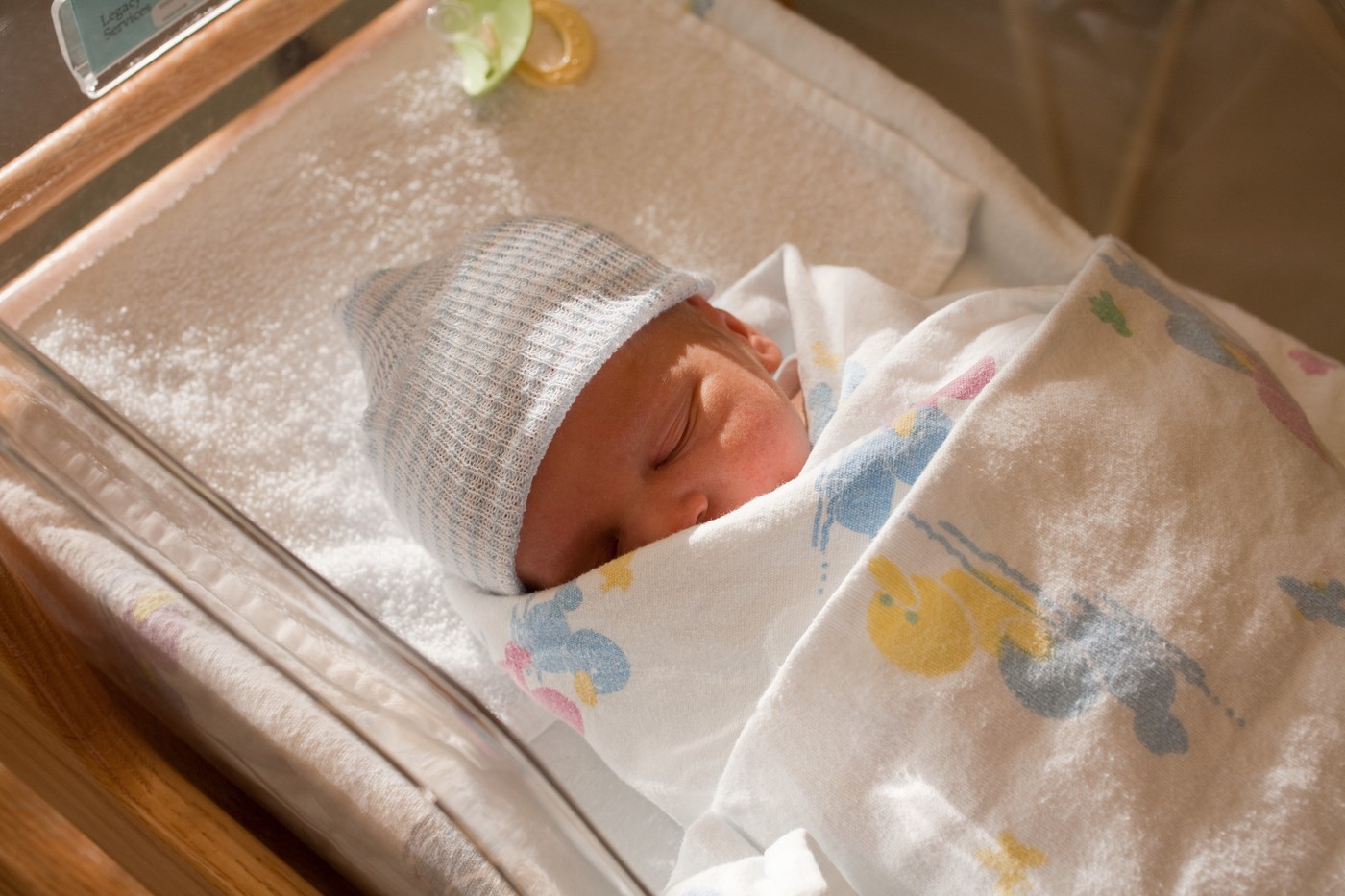 Newborn baby boy in hospital crib
