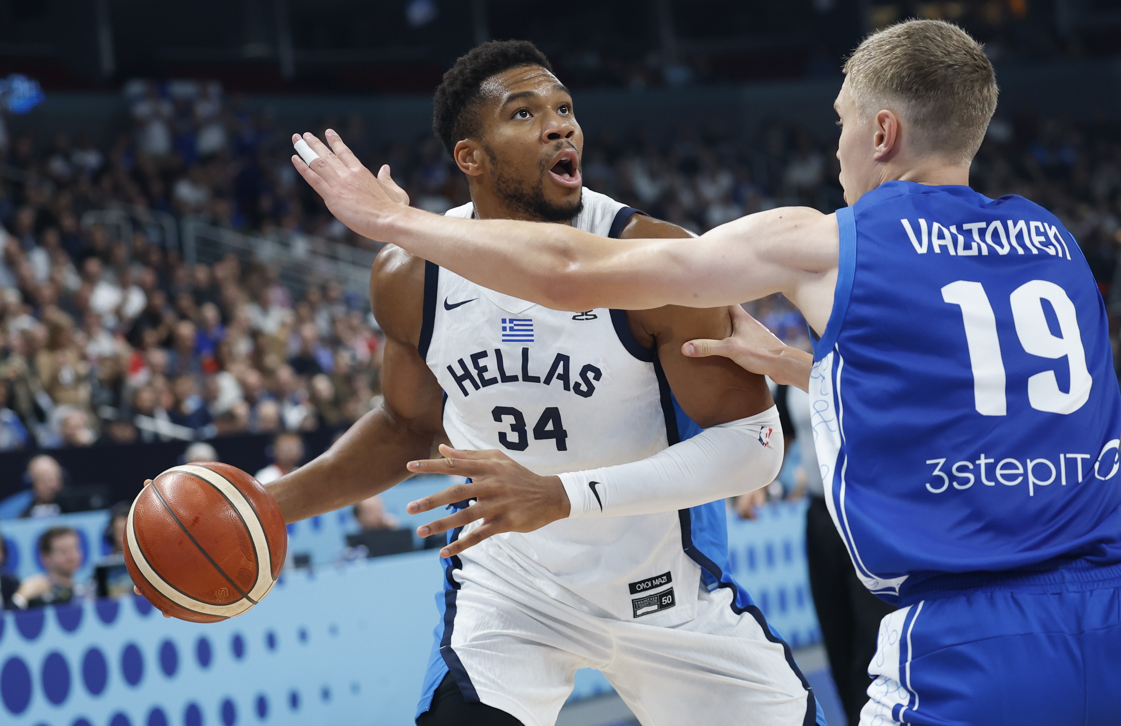 epa12376410 Giannis Antetokounmpo of Greece and Elias Valtonen (R) of Finland in action during the FIBA EuroBasket 2025 bronze medal basketball match between Greece and Finland in Riga, Latvia, 14 September 2025.  EPA/TOMS KALNINS