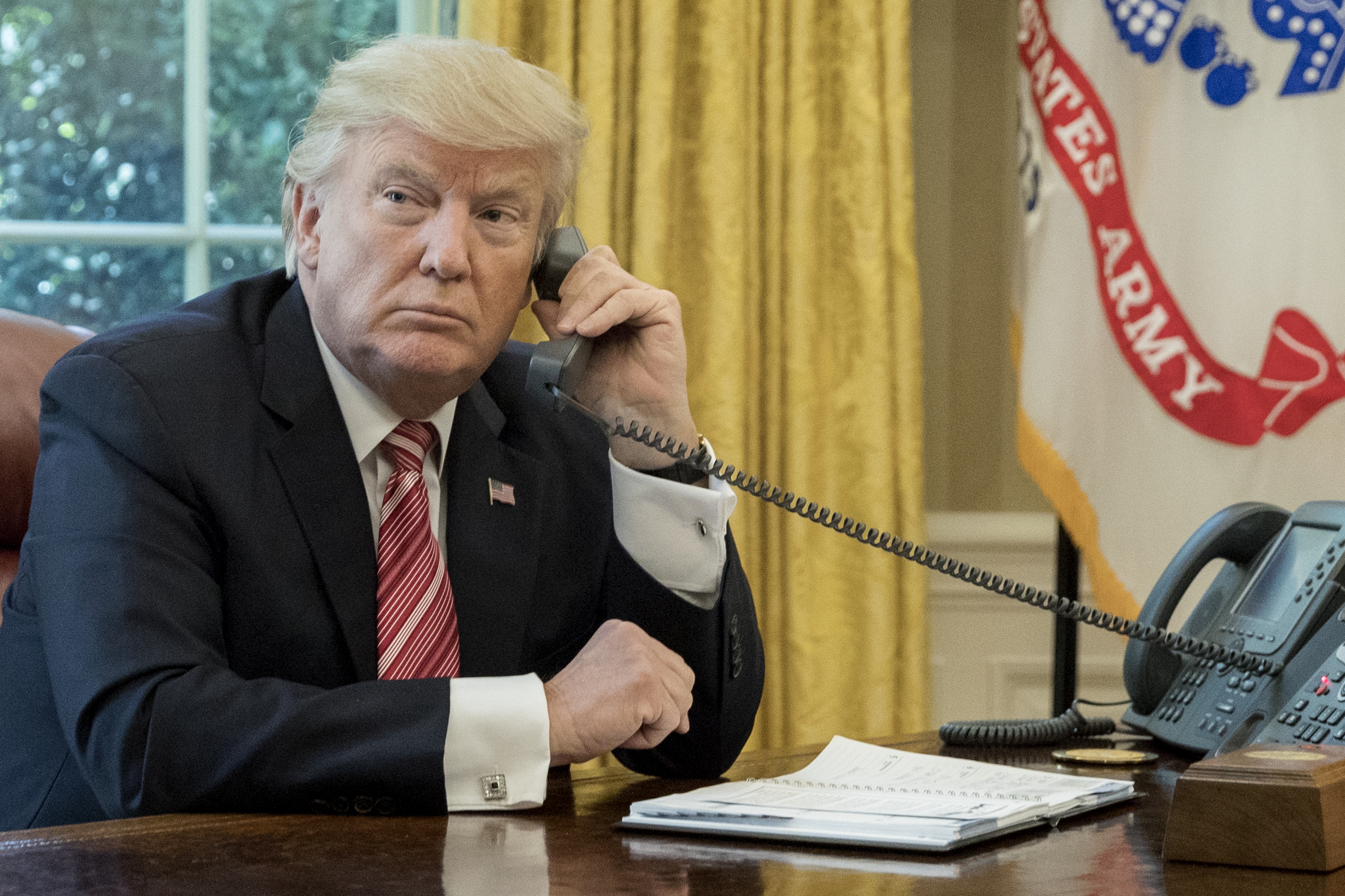 epa06052937 US President Donald J. Trump makes a phone call to  Prime Minister of Ireland to Leo Varadkar in the Oval Office of the White House in Washington, DC, USA, 27 June 2017.  EPA/MICHAEL REYNOLDS