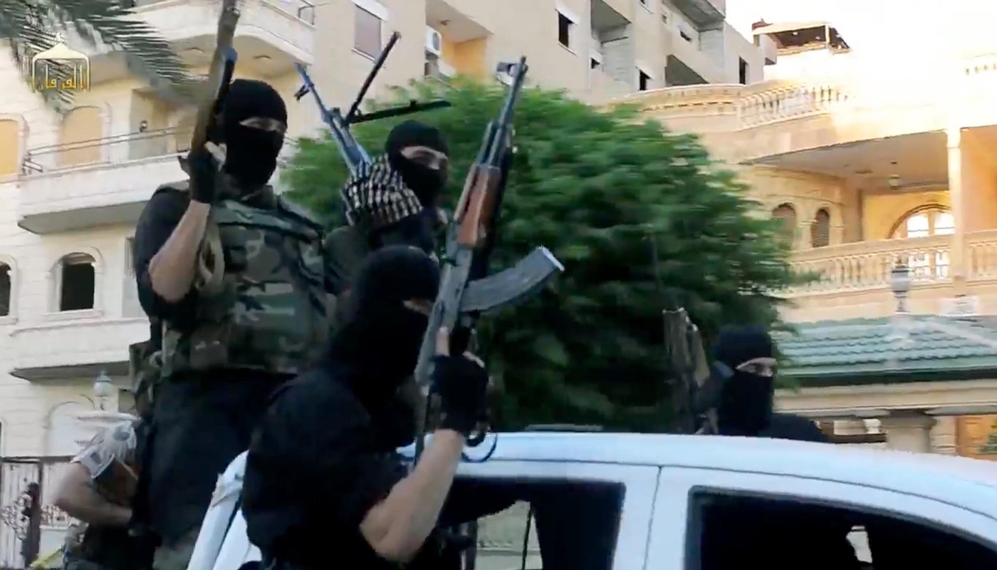 Undated propaganda video capture released by the Islamic State of Iraq and the Levant showing ISIS fighters riding through a town in Anbar Province, Iraq.