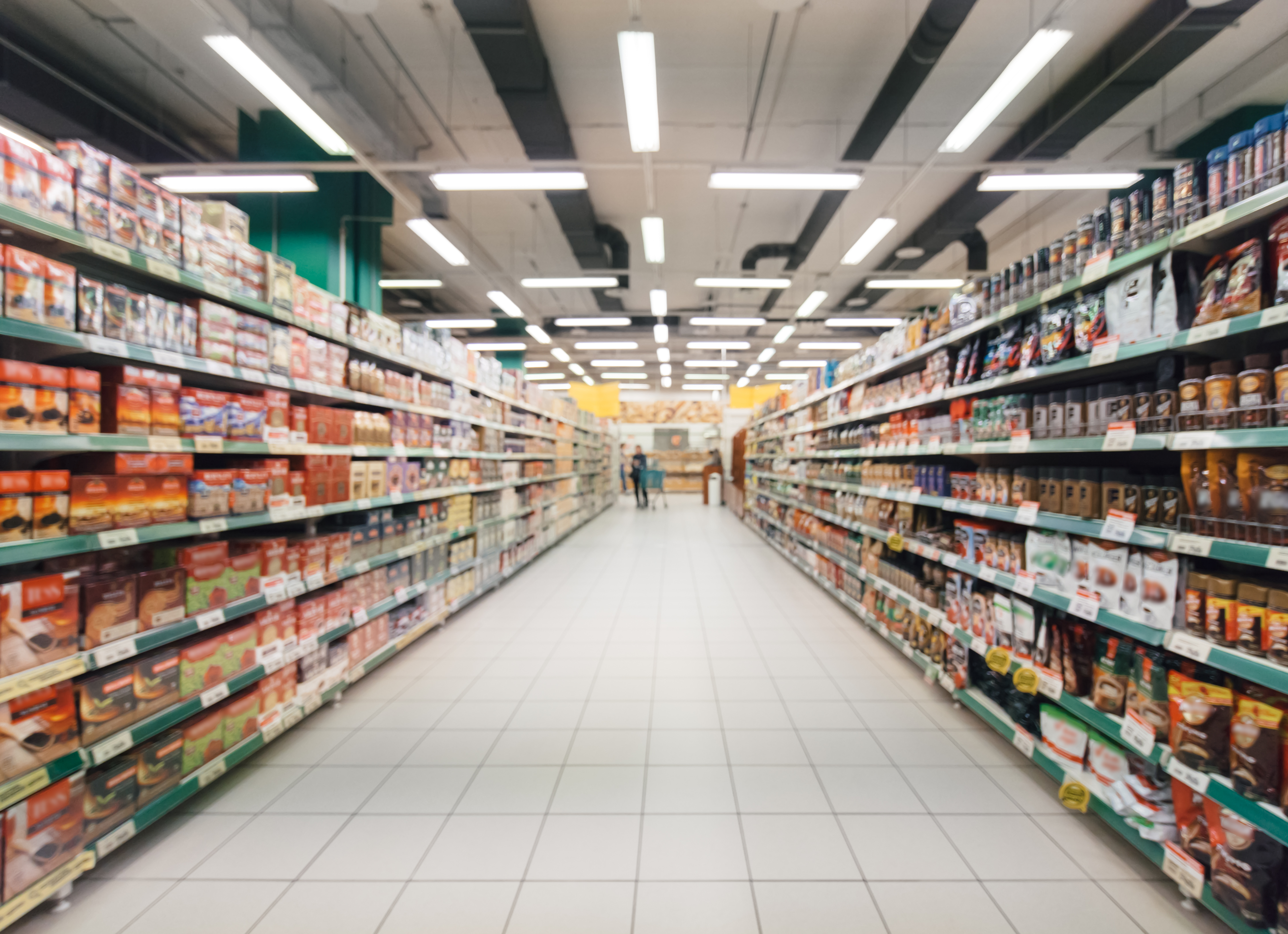 Abstract,Blurred,Supermarket,Aisle,With,Colorful,Shelves,And,Unrecognizable,Customers