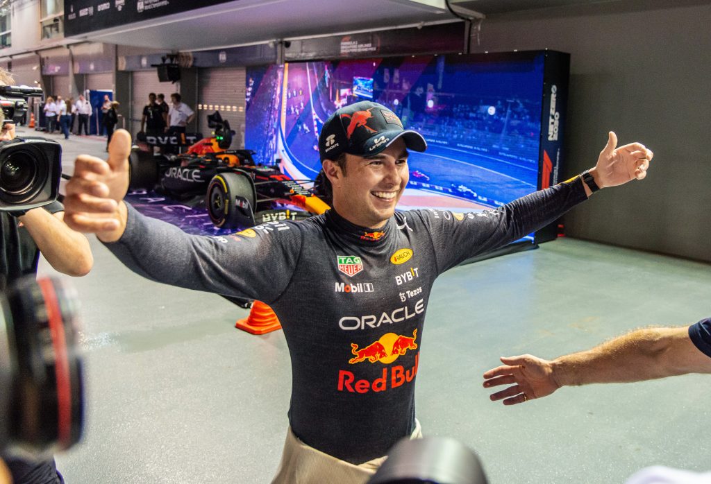 epa10219727 Mexican Formula One driver Sergio Perez of Red Bull Racing reacts after winning the Singapore Formula One Grand Prix race at the Marina Bay Street Circuit, Singapore, 02 October 2022.  EPA-EFE/TOM WHITE