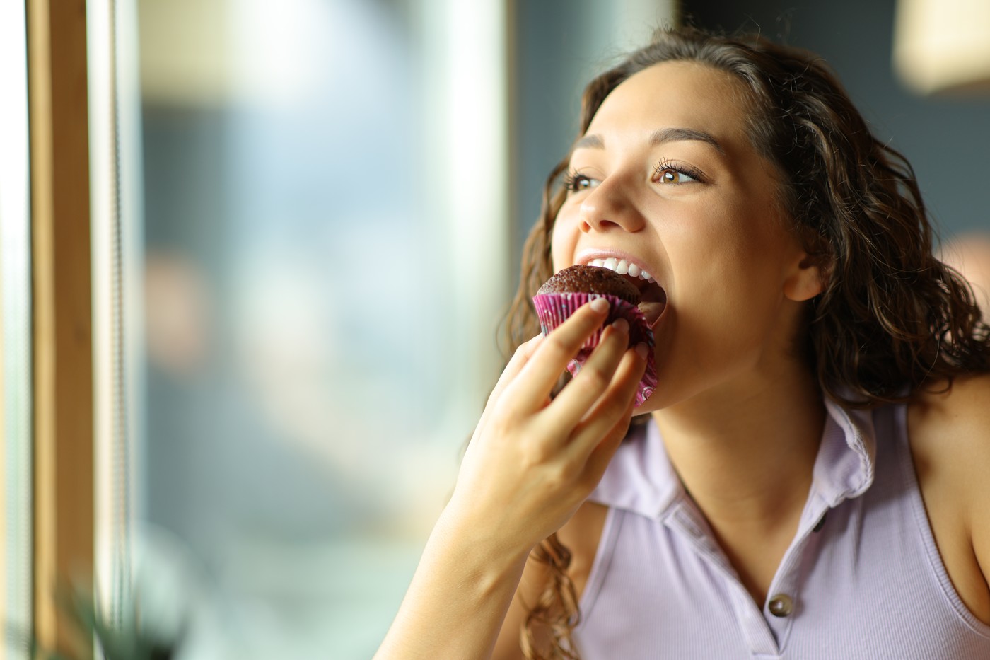 Happy woman eating chocolate cupcake in a restaurant,Image: 718936896, License: Royalty-free, Restrictions: , Model Release: yes, Credit line: Antonio Guillem Fernandez / Panthermedia / Profimedia