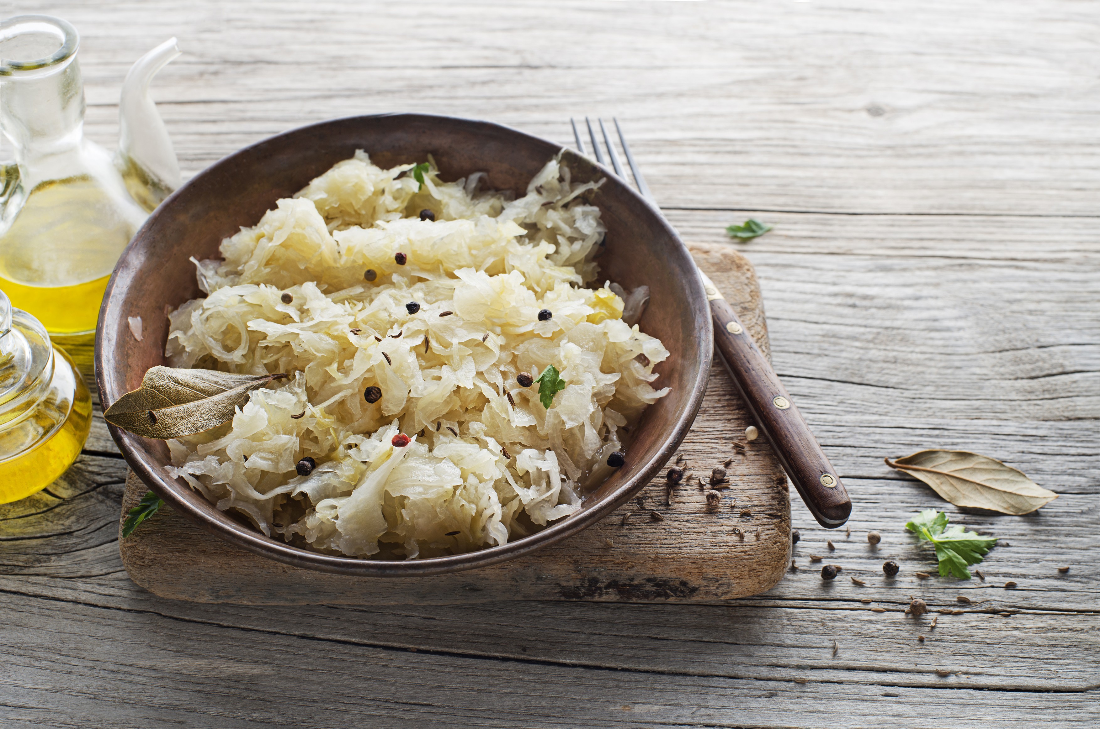 Homemade sauerkraut with black pepper and parsley in bowl on rustic background. Copy space.,Image: 751860331, License: Royalty-free, Restrictions: , Model Release: no, Credit line: Dusan Zidar / Panthermedia / Profimedia